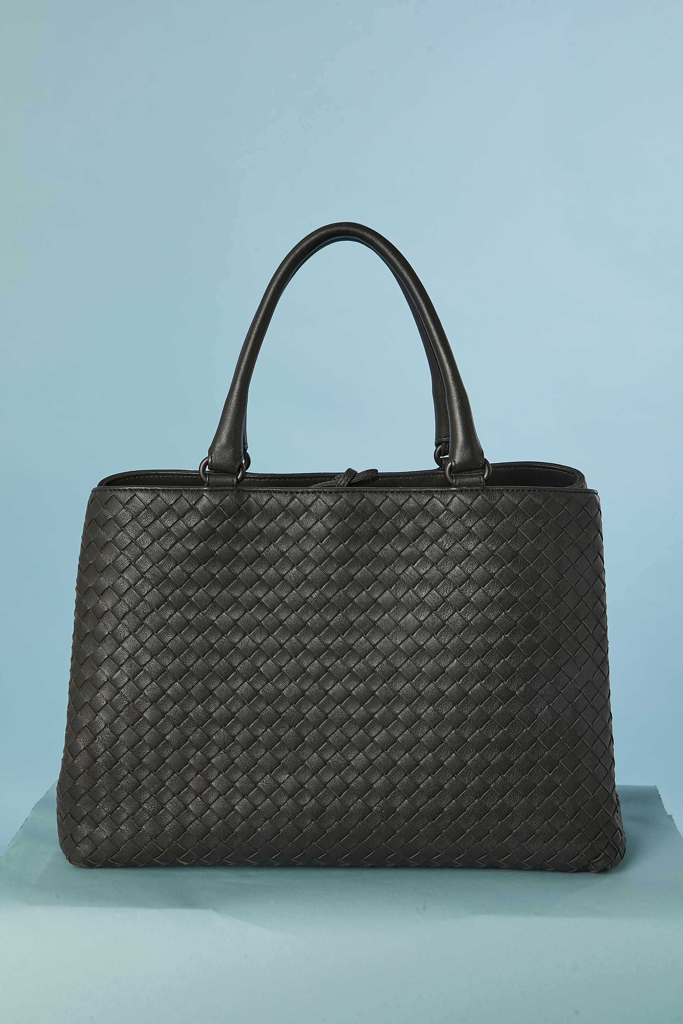 Bolso de asa superior marrón de piel entrelazada. Forro de algodón. La bolsa consta de 2 compartimentos con 2 bolsillos planos en el interior ( uno con cierre de cremallera) 
Cordón de cuero en el cierre superior central. 
TAMAÑO : 35cm X 24cm X