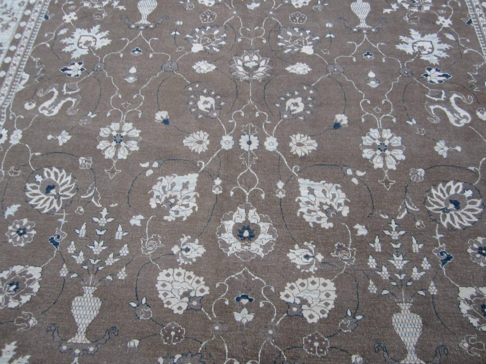 Brown, beige, taupe and blue tones make this elegant traditional style area rug one of the most versatile rugs you'll find. Hand knotted wool also makes it one of the most durable. Great for the living room or bedroom. Made in Pakistan using vegetal