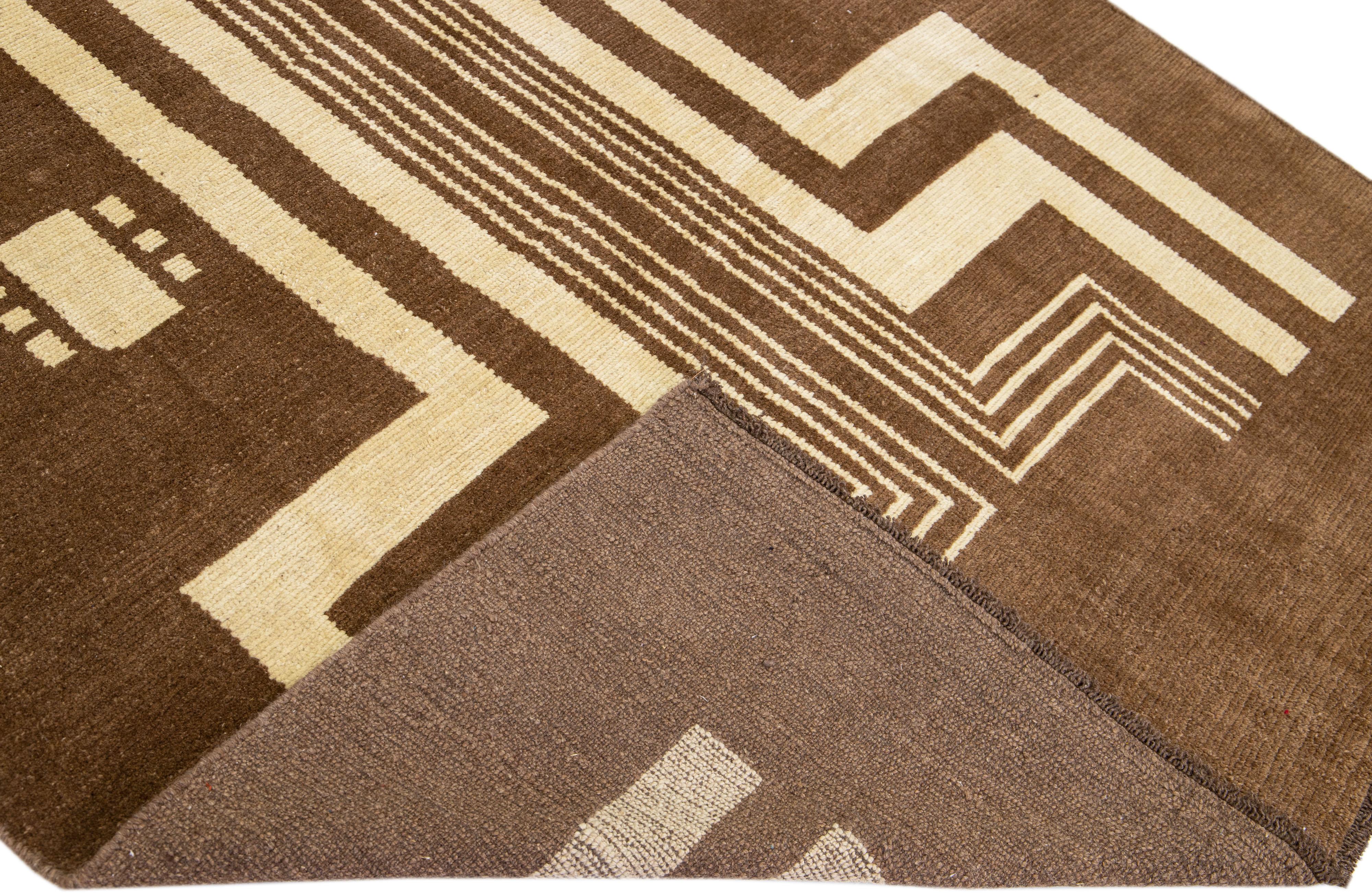 This Beautiful Modern Art Deco handmade wool rug makes part of our Northwest collection and features a brown color field and beige accents in a gorgeous geometric tribal design.

This rug measures: 6'4