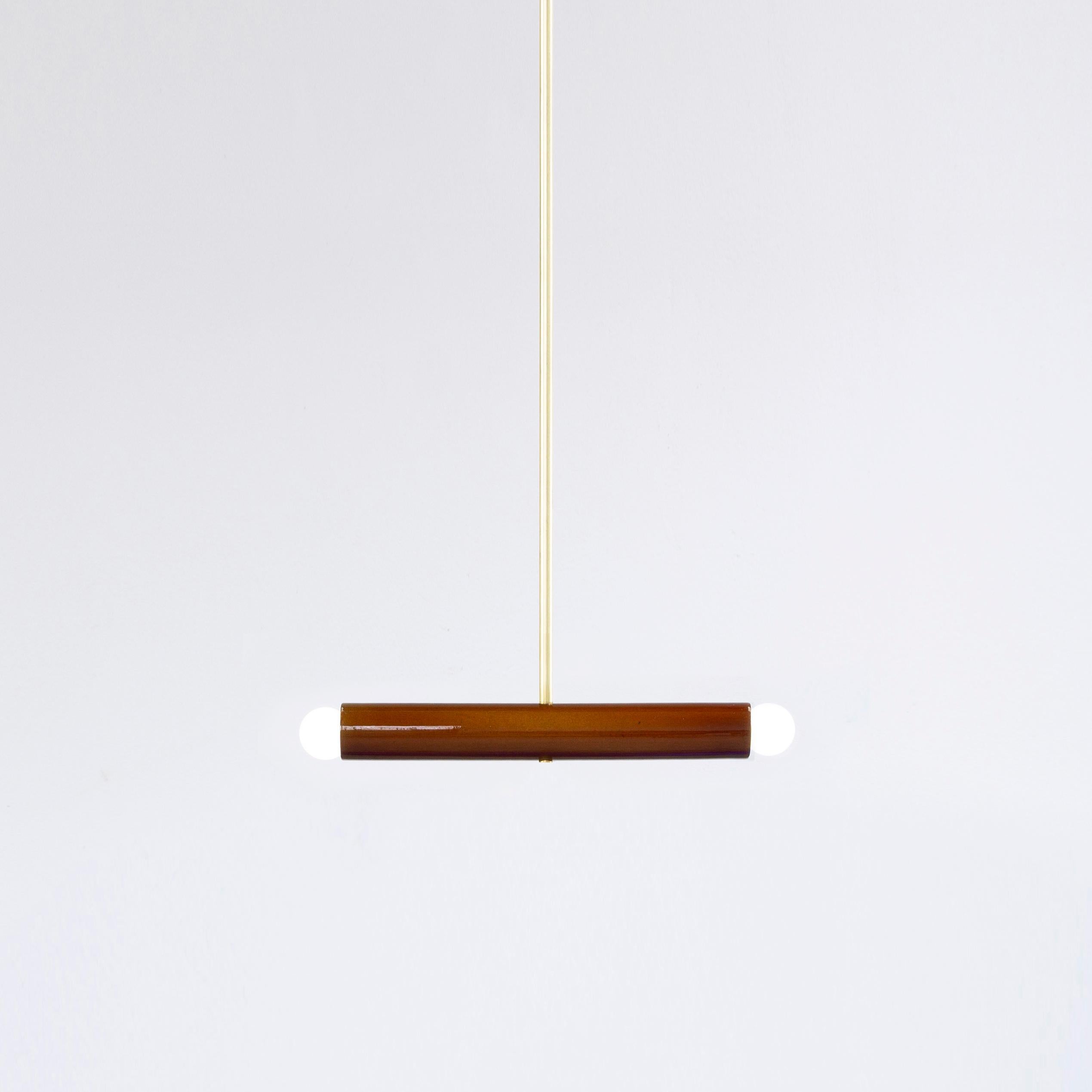 Brown TRN A2 pendant lamp by Pani Jurek
Dimensions: D 5 x W 35 x H 5 cm 
Material: Hand glazed ceramic and brass.
Available in other colors.
Lamps from the TRN collection hang on a metal tube, not on a cable. This allows the lamp to be mounted in a