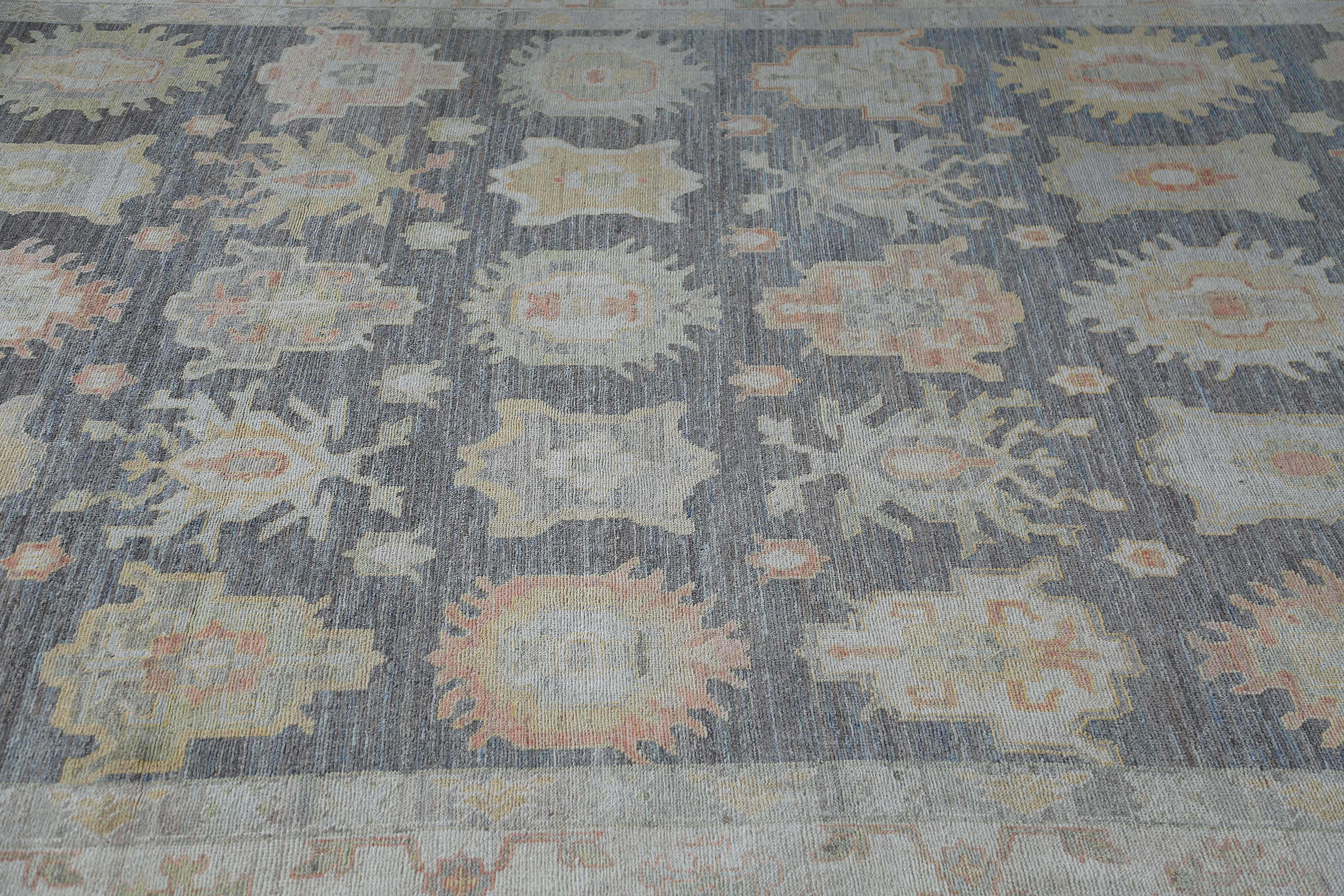 Introducing our exquisite handwoven Oushak rug in a rich shade of brown, enhanced with delicate light tones that lend it a gentle air. This rug is generously sized at 10'4'' x 13'3'', offering ample coverage to enhance the look of any space with its