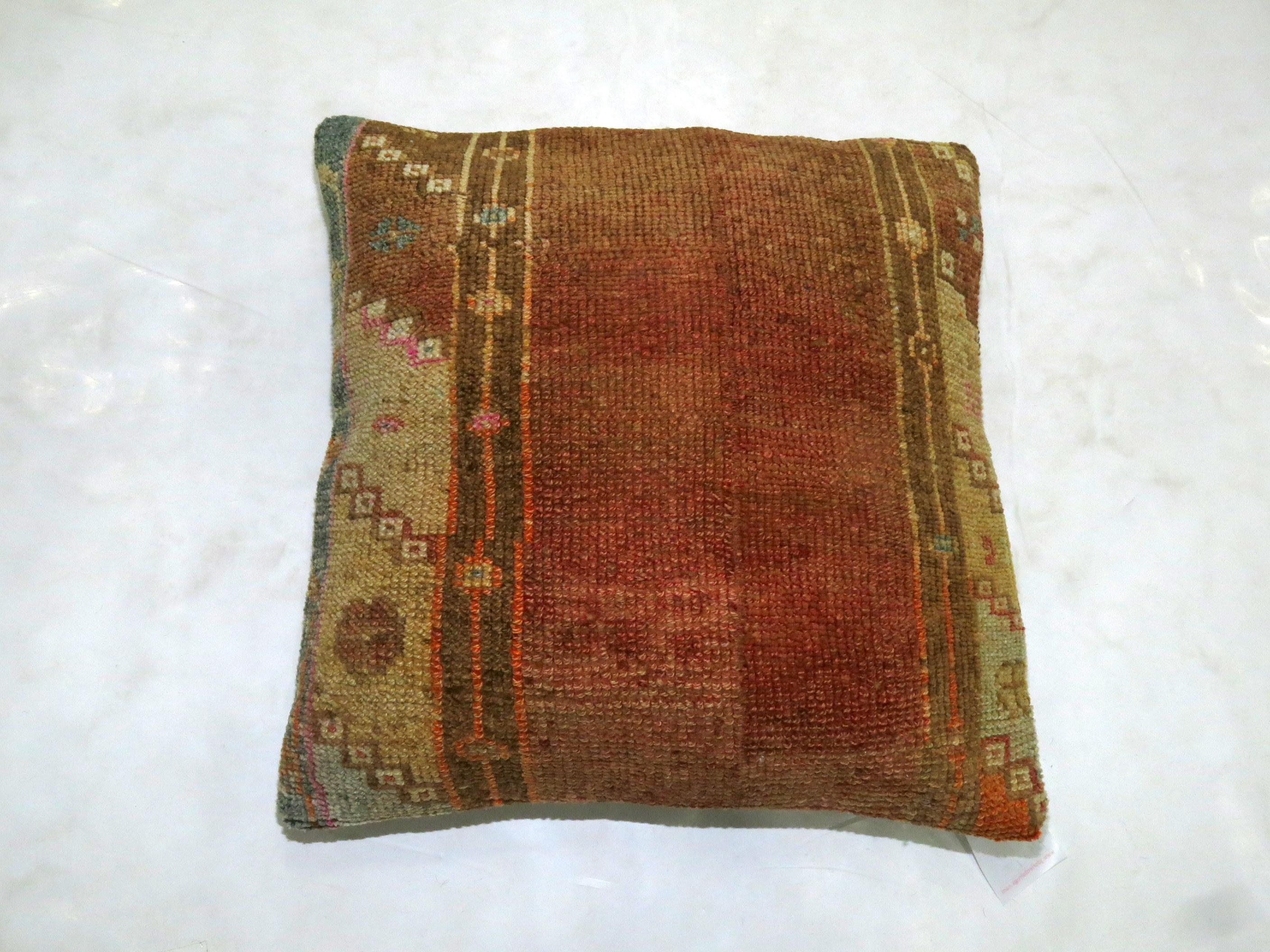 Square size pillow made from a vintage Turkish Anatolian rug. Brown, orange, soft green, lavender accents

Measures: 20” x 20”.