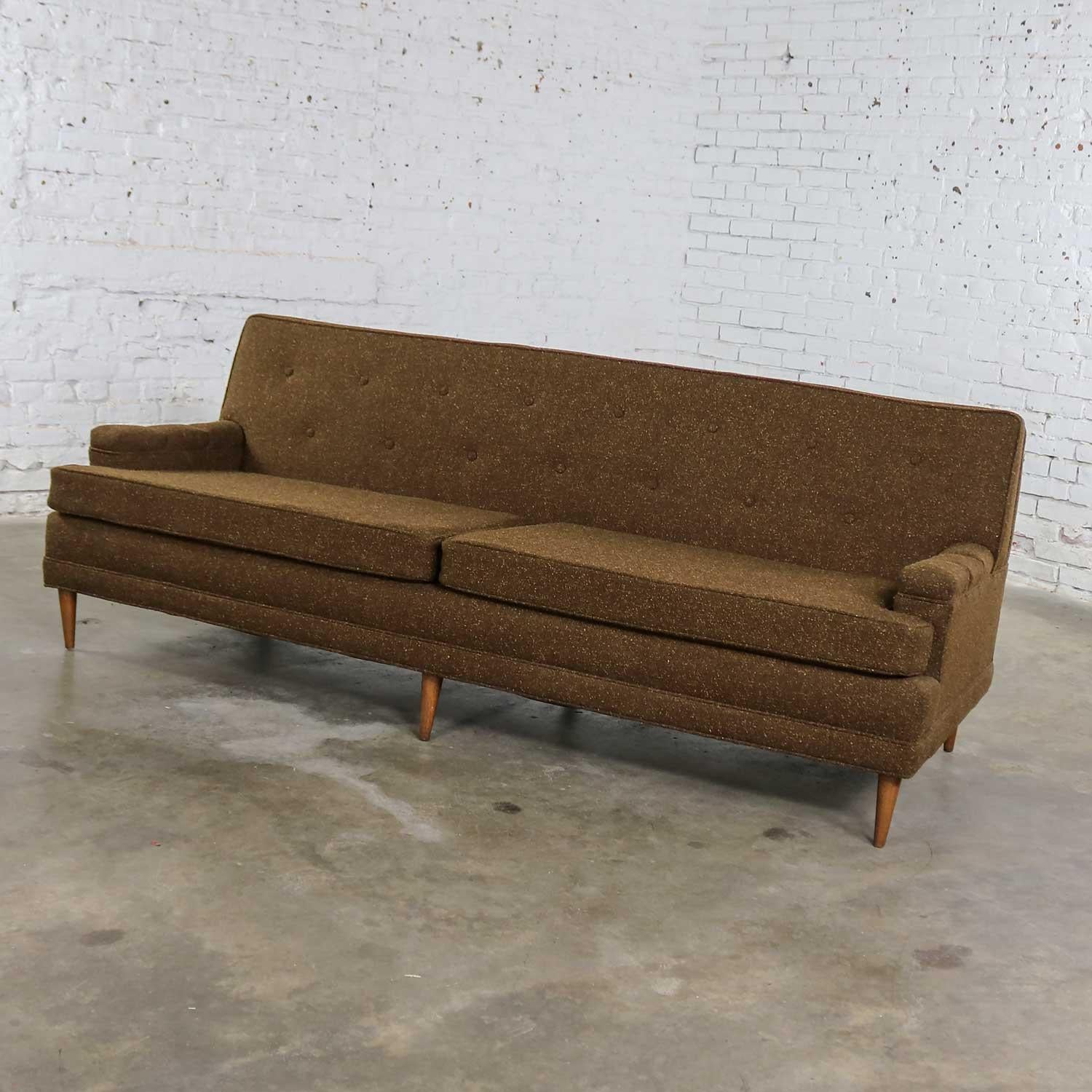 Handsome MCM sofa in a Lawson style with a tight button back and covered in a nice brown tweed. It is made in the manner of Milo Baughman or Edward Wormley.  Beautiful condition, keeping in mind that this is vintage and not new so will have signs of