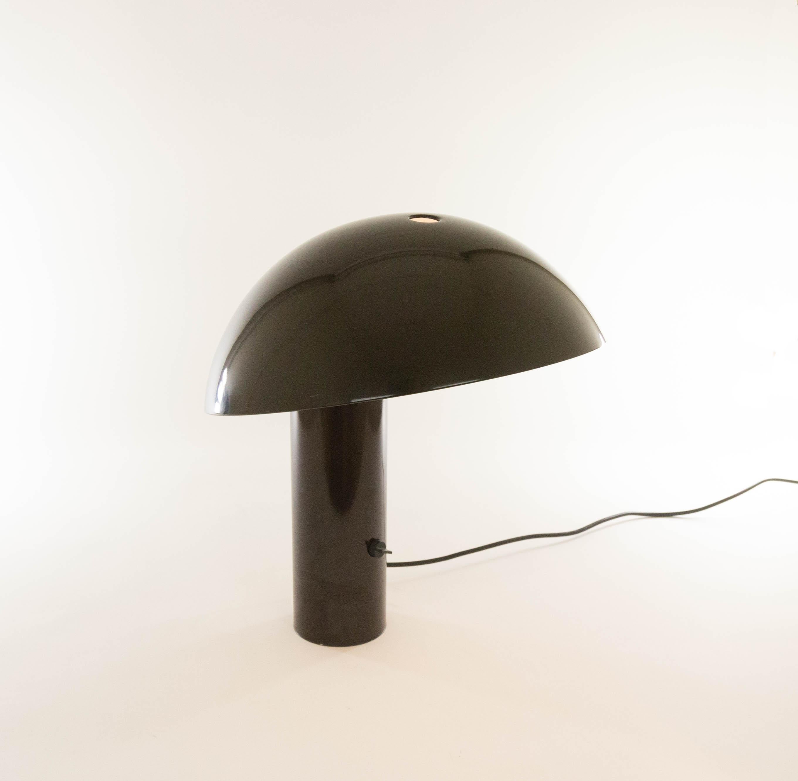 Brown table lamp, model Vaga, designed by Franco Mirenzi in 1978 and produced by Valenti Luce.

The relatively heavy base provides a solid balance for the fairly large round metal top of the lamp. The lamp is made of metal and the on / of switch