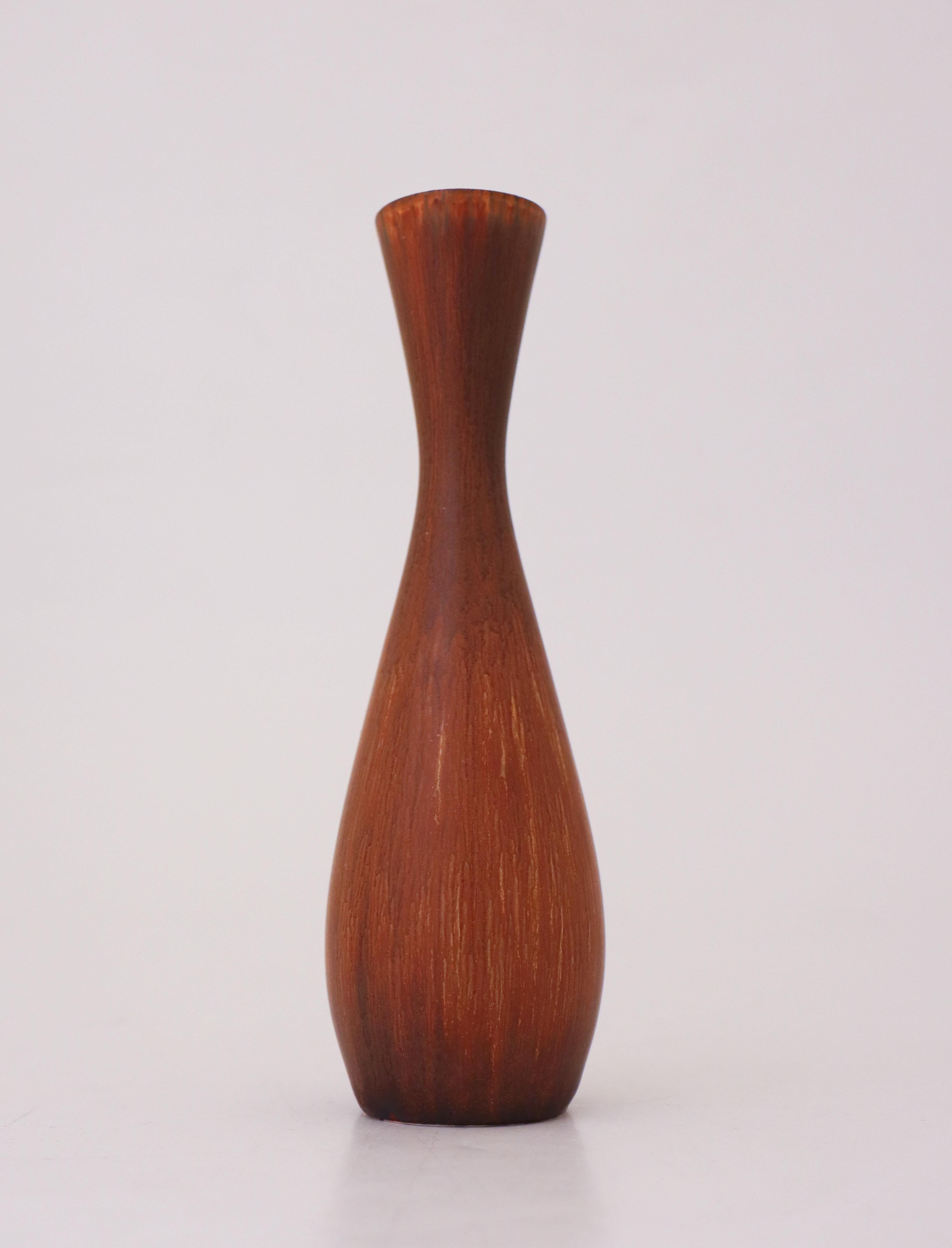 A vase with a brown glaze designed by Carl-Harry Stålhane at Rörstrand, the vase is in excellent condition except from a minor crack below. It is marked as 2nd quality. 

Carl-Harry Stålhane is one of the top names when it comes to Mid century