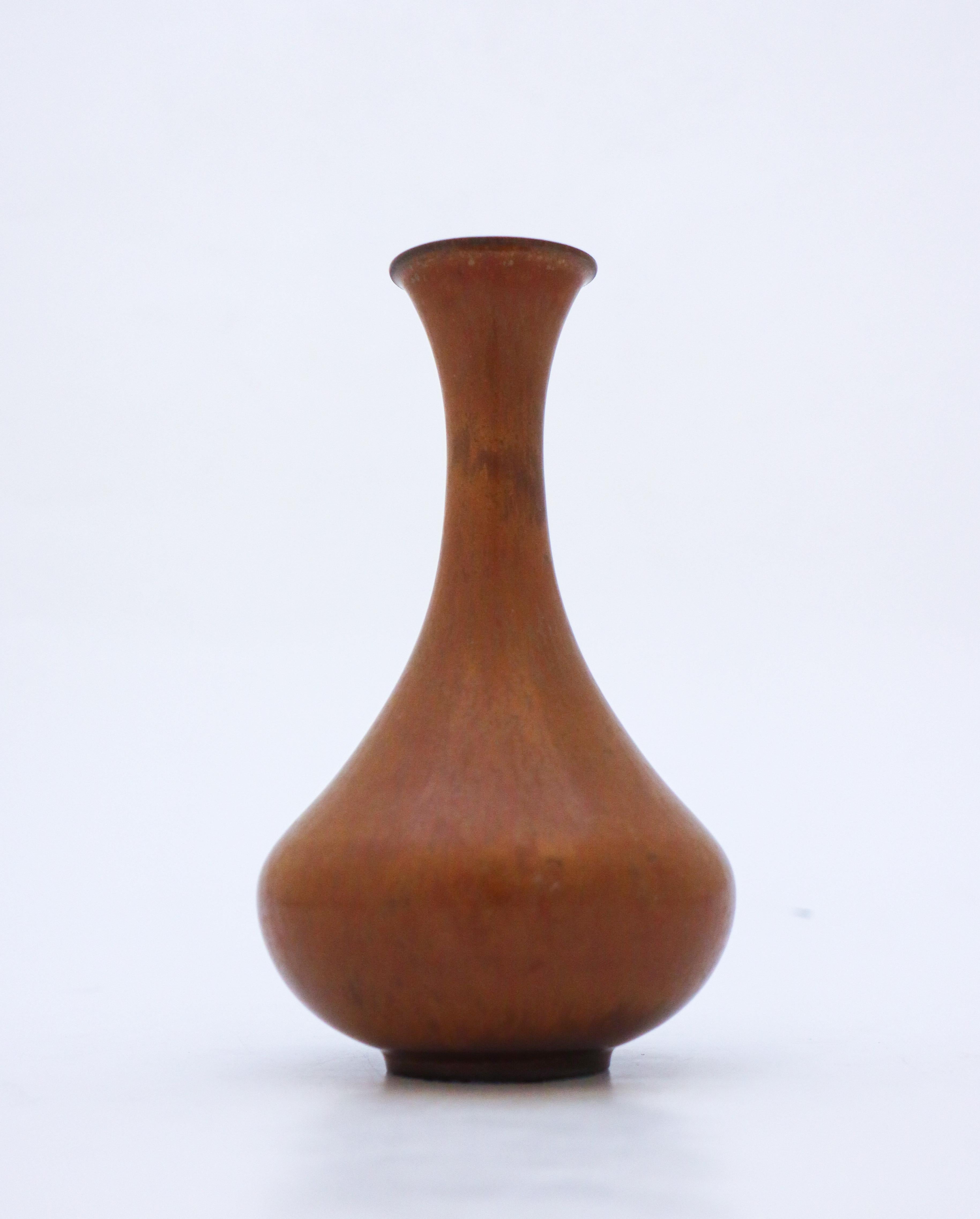 Vase brun conçu par Gunnar Design/One chez Rörstrand, d'une hauteur de 16,5 cm (6,6 po). Il est en parfait état et marqué comme étant de qualité 1:st. 

Gunnar Nylund est né à Paris en 1904 de parents sculpteurs et designers. Il a donc très vite