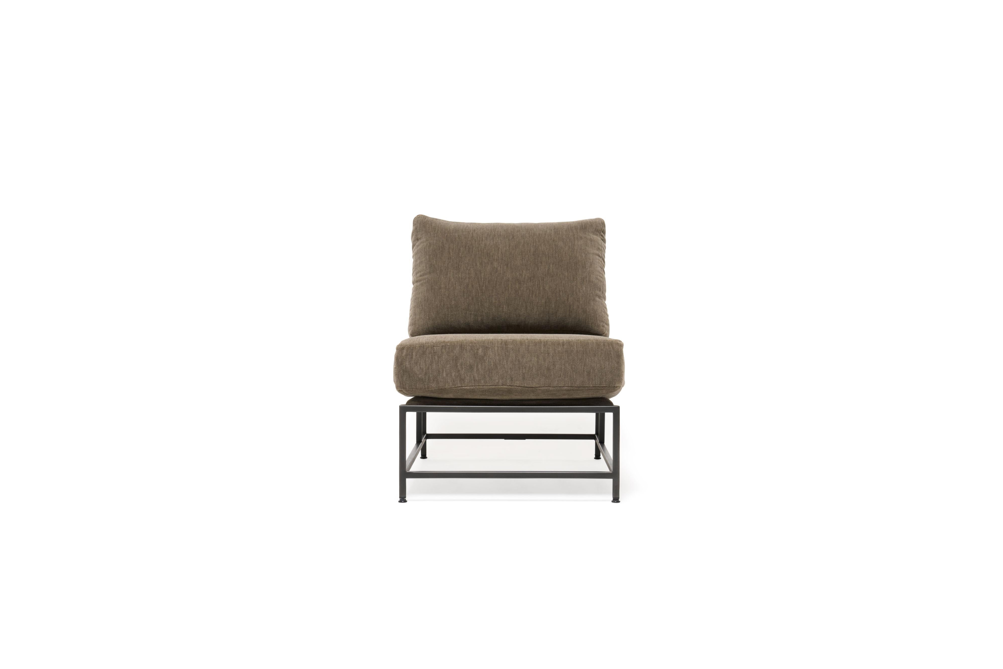 The Inheritance Chair by Stephen Kenn is as comfortable as it is unique. The design features an exposed construction composed of three elements - a steel frame, plush upholstery, and supportive belts. The deep seating area is perfect for a relaxing