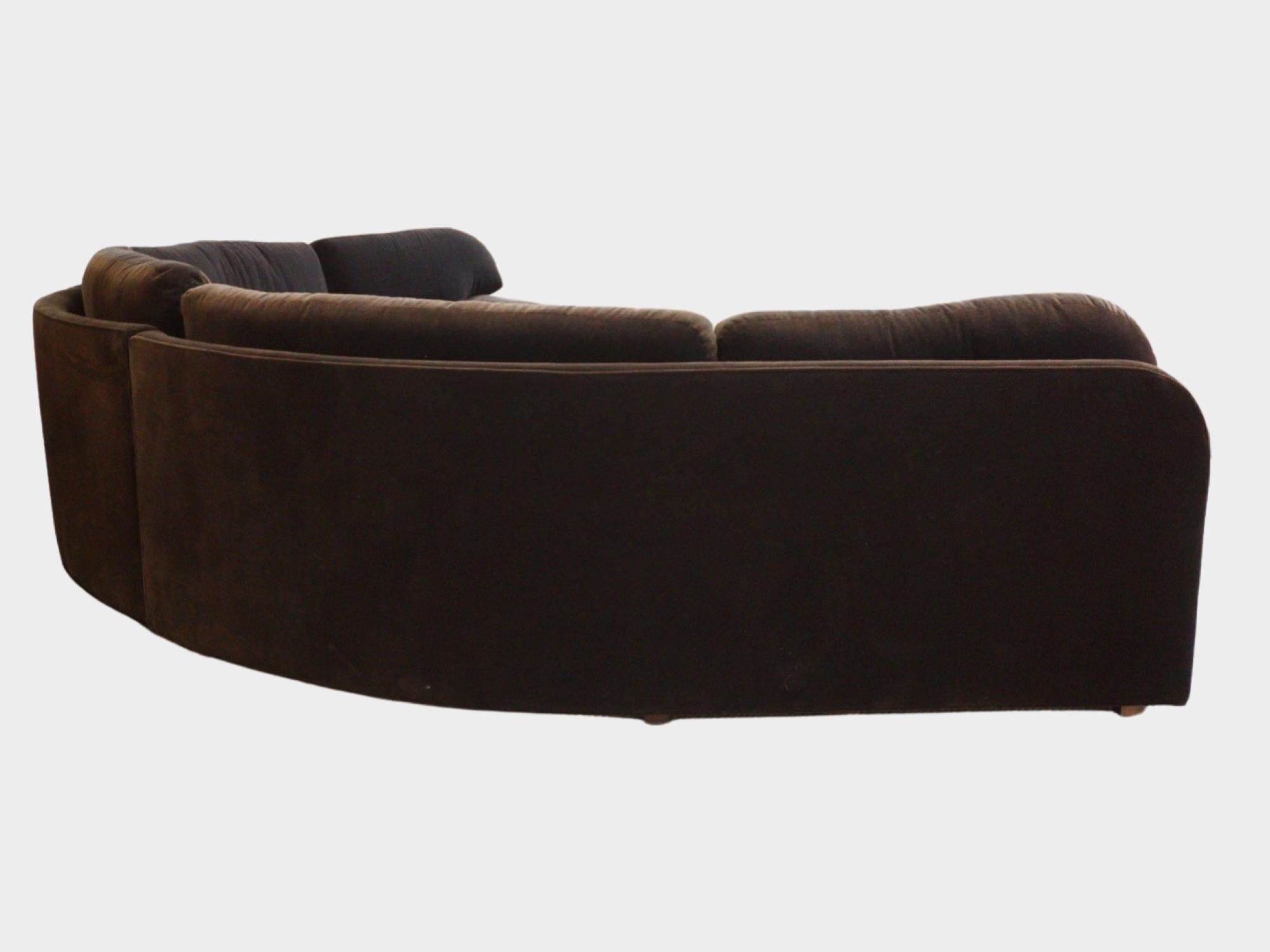 Imagine lounging on this colossal, Vladimir Kagan-inspired curved sectional, a masterpiece of the 1980s now reinvented with a lush brown velvet garb. Its audacious curves whisper of Kagan's genius, blending sculpture with function, while the velvet