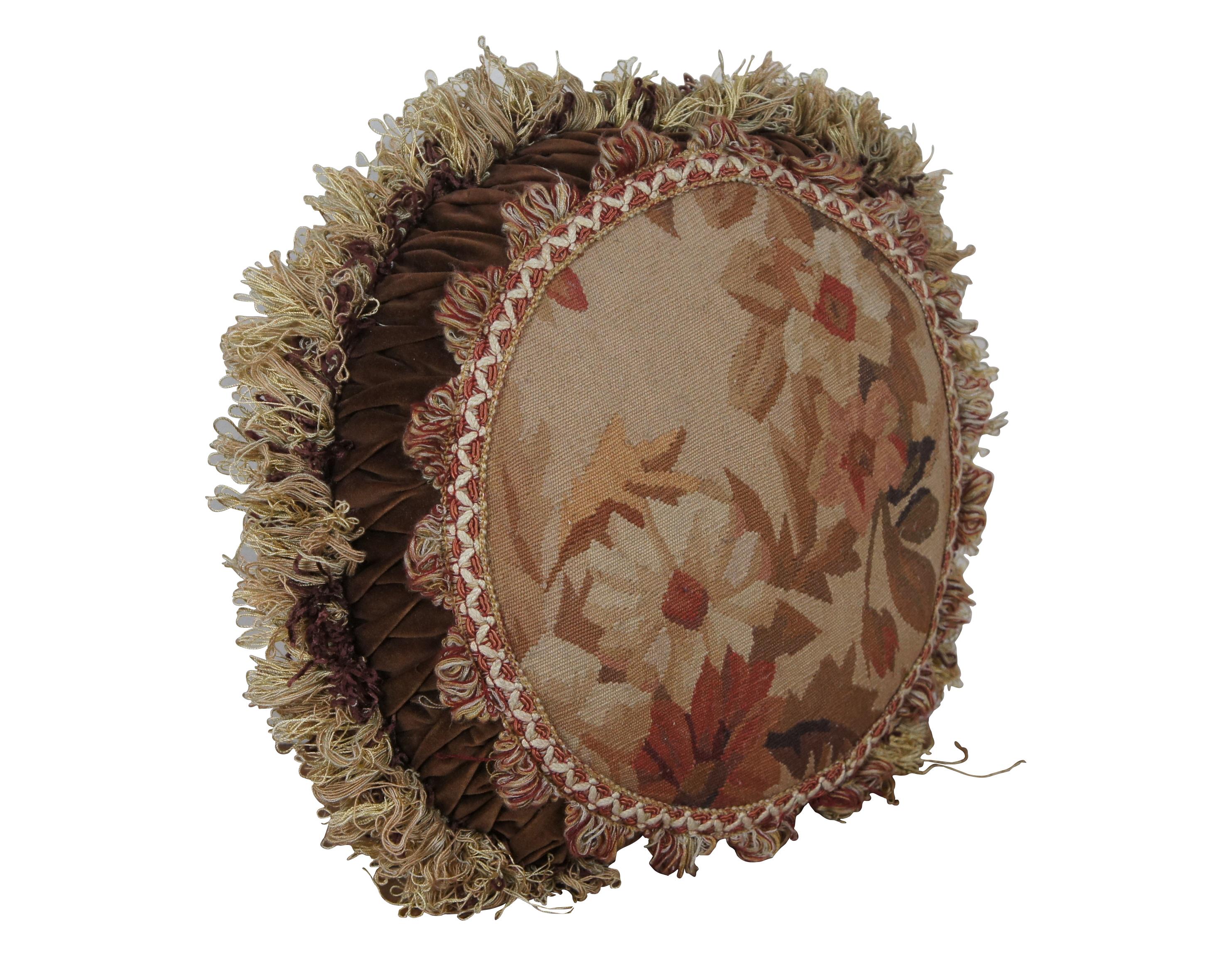 20th century round French style throw / accent pillow, embroidered with brown, cream and rust colored flowers, framed in white and rose colored trim, ruched velvet, and burgundy and cream colored fringe. Brown velour / velvet back with zipper