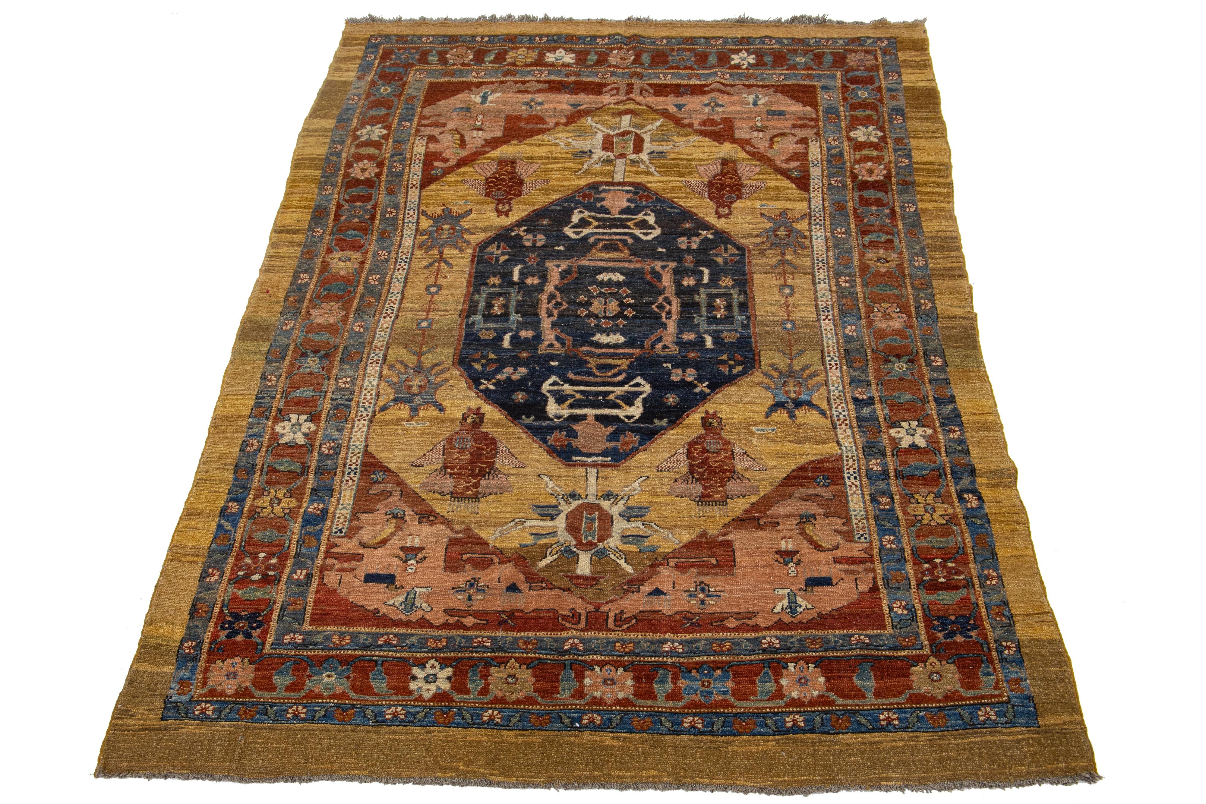 Beautiful vintage Bakshaish hand-knotted wool rug with a tan and brown color field. This Persian rug has the fame of rust, with blue and beige accents in an all-over geometric medallion design.

This rug measures 7' x 11'.