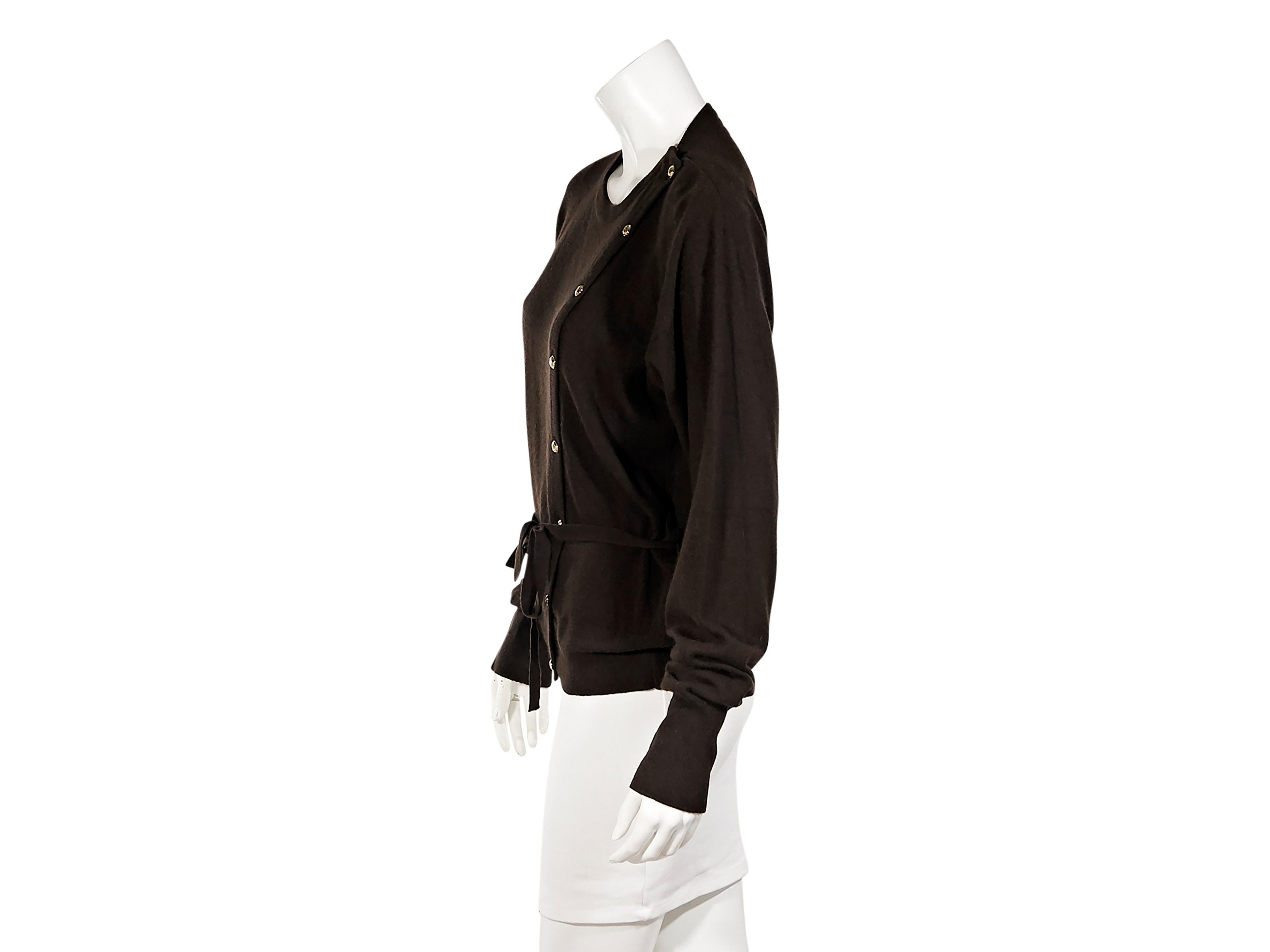 Product details:  Vintage brown cashmere sweater by Chanel.  Roundneck.  Long sleeves.  Asymmetrical button-front closure.  Self-tie belted waist.  Goldtone hardware.  36