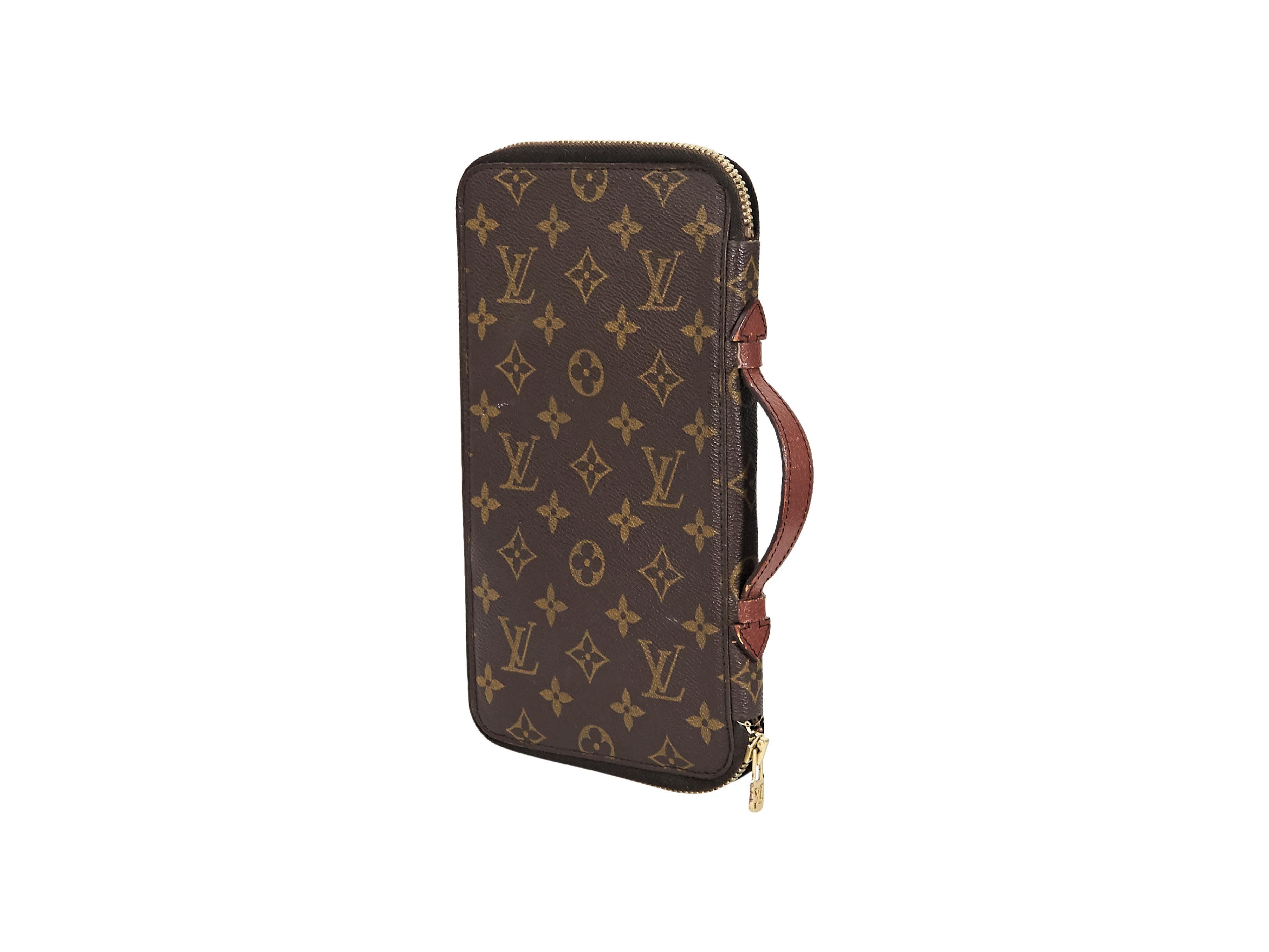 Product details:  Vintage brown monogram coated canvas travel portfolio by Louis Vuitton.  Side leather carry handle.  Zip-around closure.  Inner card slots, snap flap pouch and slide pockets.  Goldtone hardware.  6