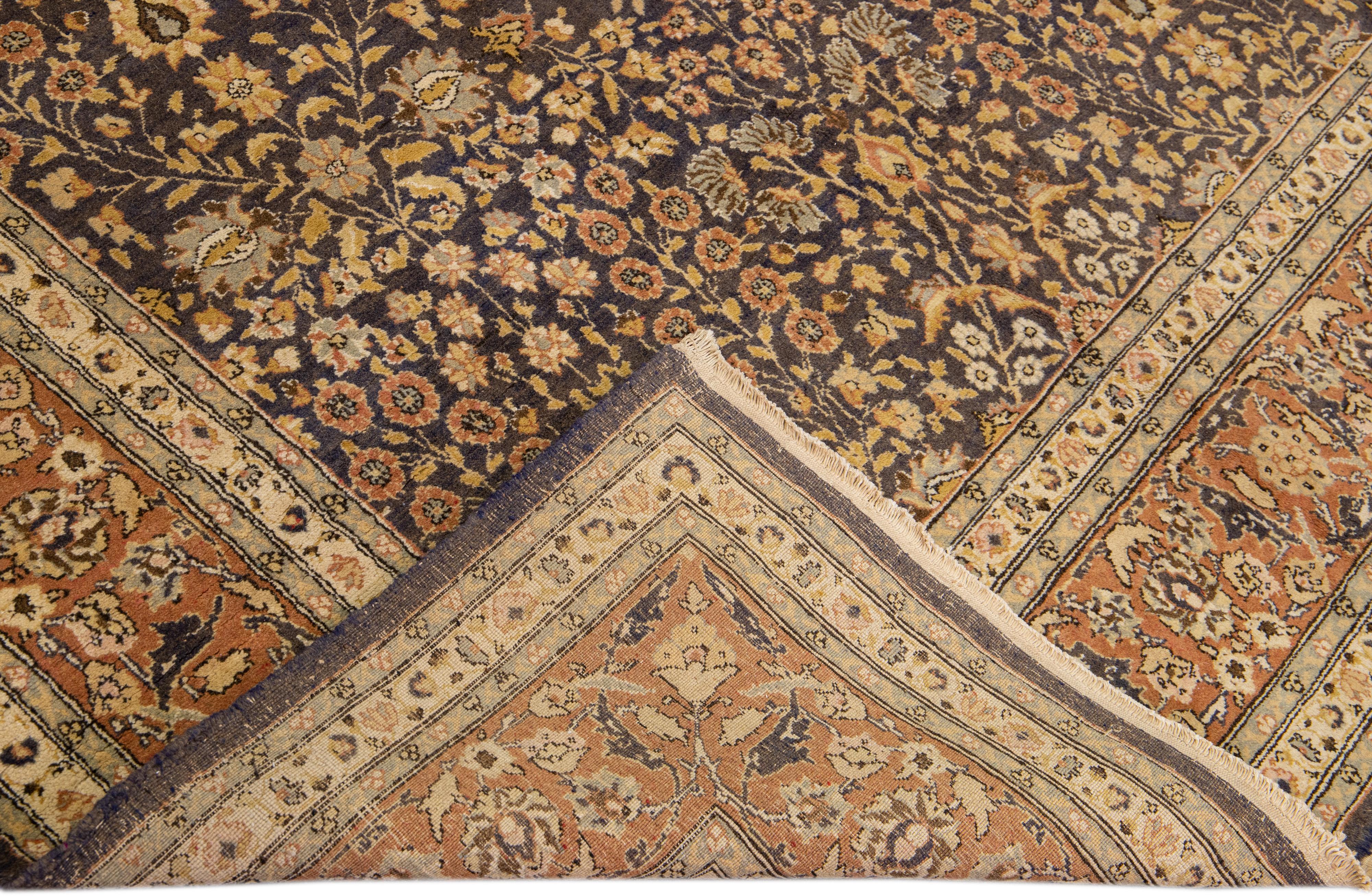Beautiful Vintage hand-knotted wool rug with a blue field. This Tabriz rug has a rusted frame with yellow and gray accents in a gorgeous all-over geometric floral design.

This rug measures: 5'5
