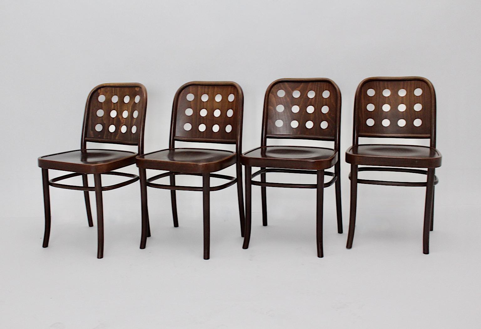 A brown vintage set of 4 dining chairs beech style Josef Hoffmann, which were made in 1990s.
The Chairs were made out of brown stained and colorless lacquered bentwood and plywood.
While the backseat shows an interesting form with significant 12