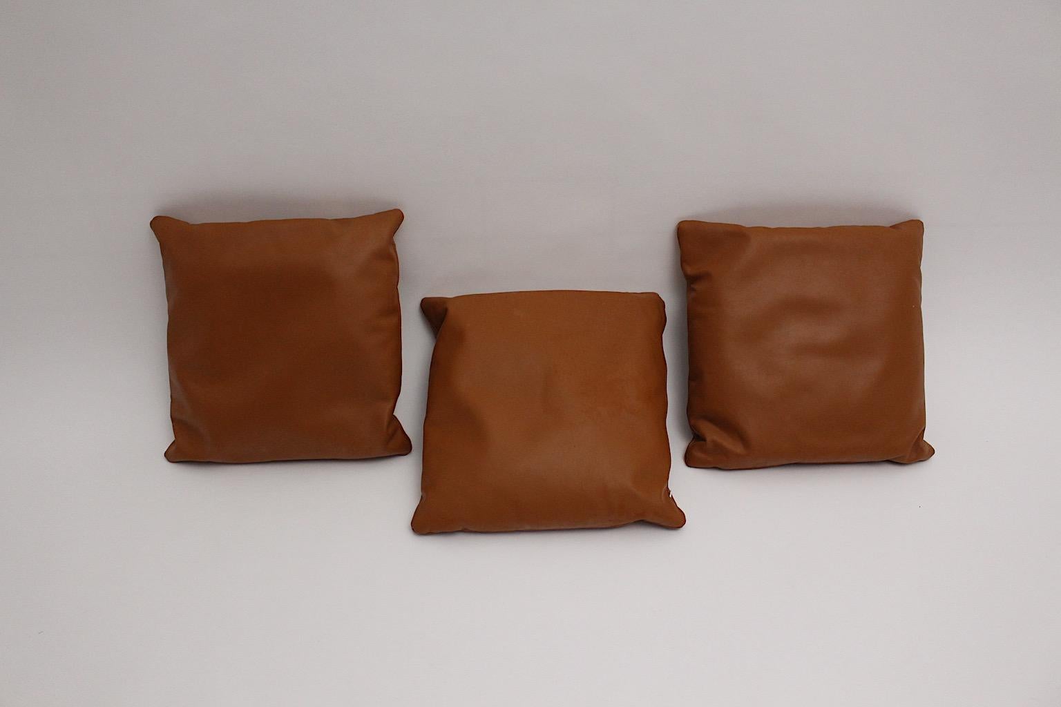 A brown vintage stitched set of three leather pillows, which were designed and made 1970s, Switzerland.
The pillows show beautiful warm cognac brown tone and a squared shape.
To open with a zipper.
The vintage condition is very good with great