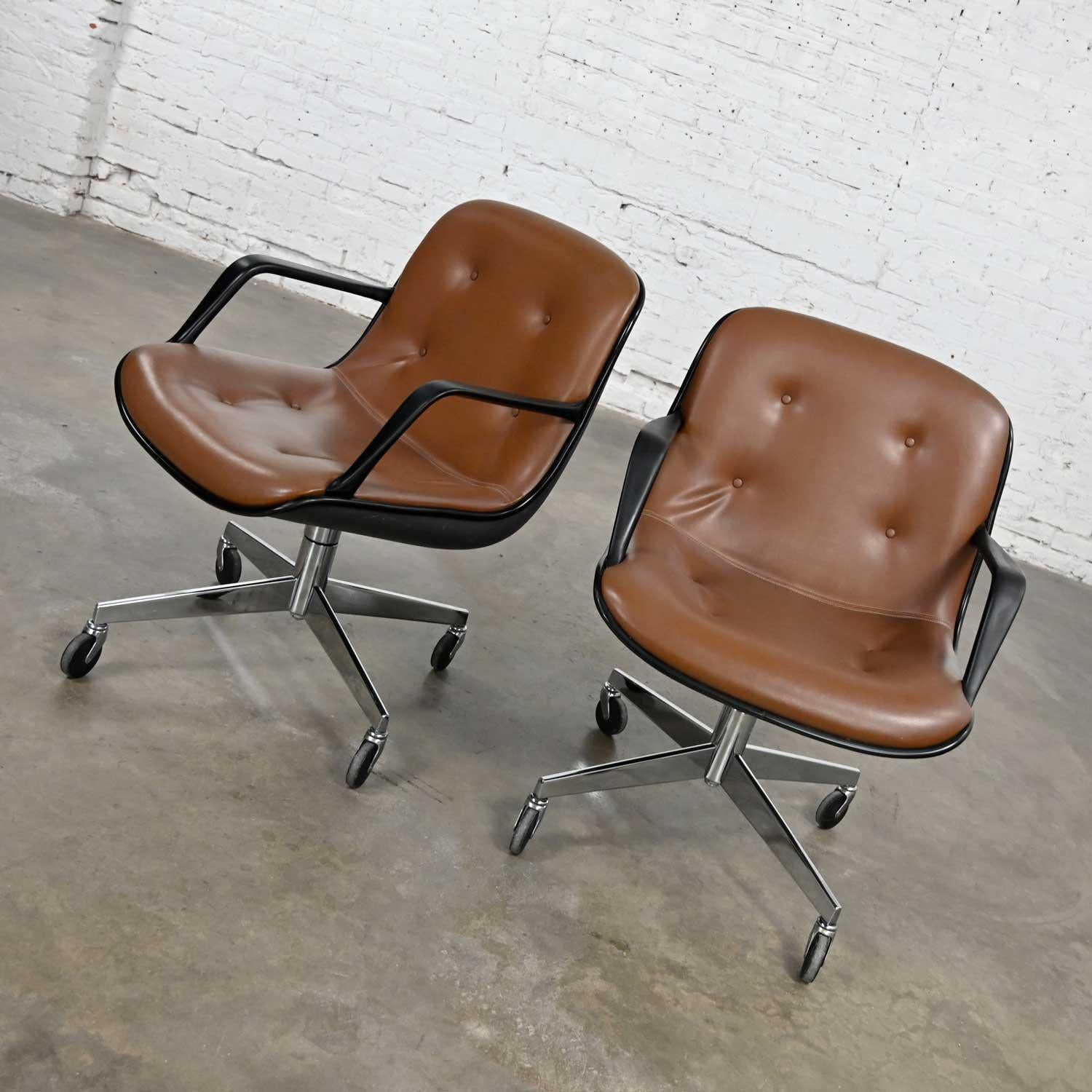 Handsome pair of brown vinyl faux leather MCM (a.k.a.) Mid-Century Modern style Steelcase 451 office chairs with 4 prong base on casters in the style of the Charles Pollock office chair for Knoll with height adjustment, swivel, and rolling features.