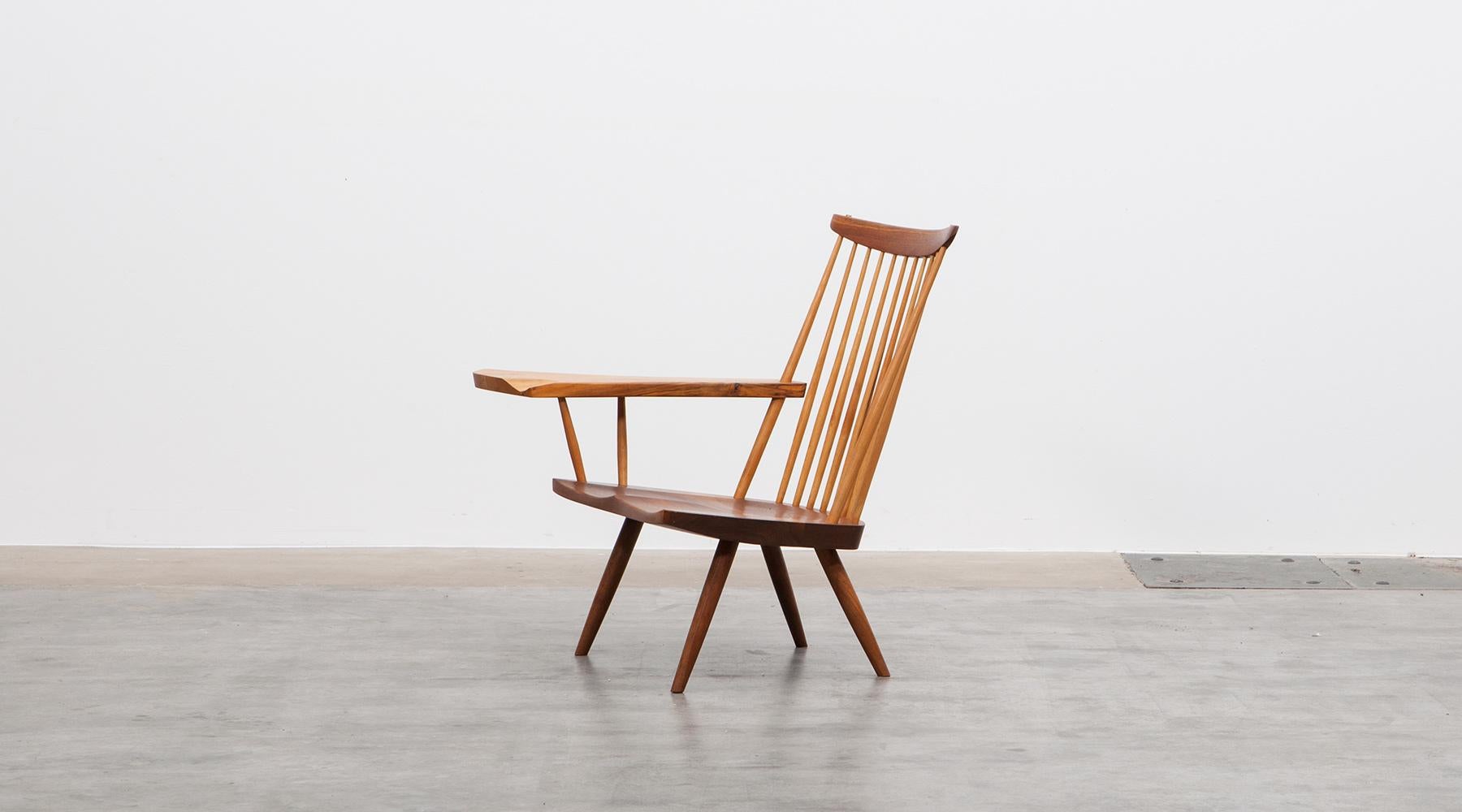 Armchair in walnut designed by George Nakashima, USA, 2003.

This handcrafted armchair by George Nakashima has a beautifully figured American walnut armrest with an organic and subtle freeform edge. Manufactured by Mira Nakashima studios in