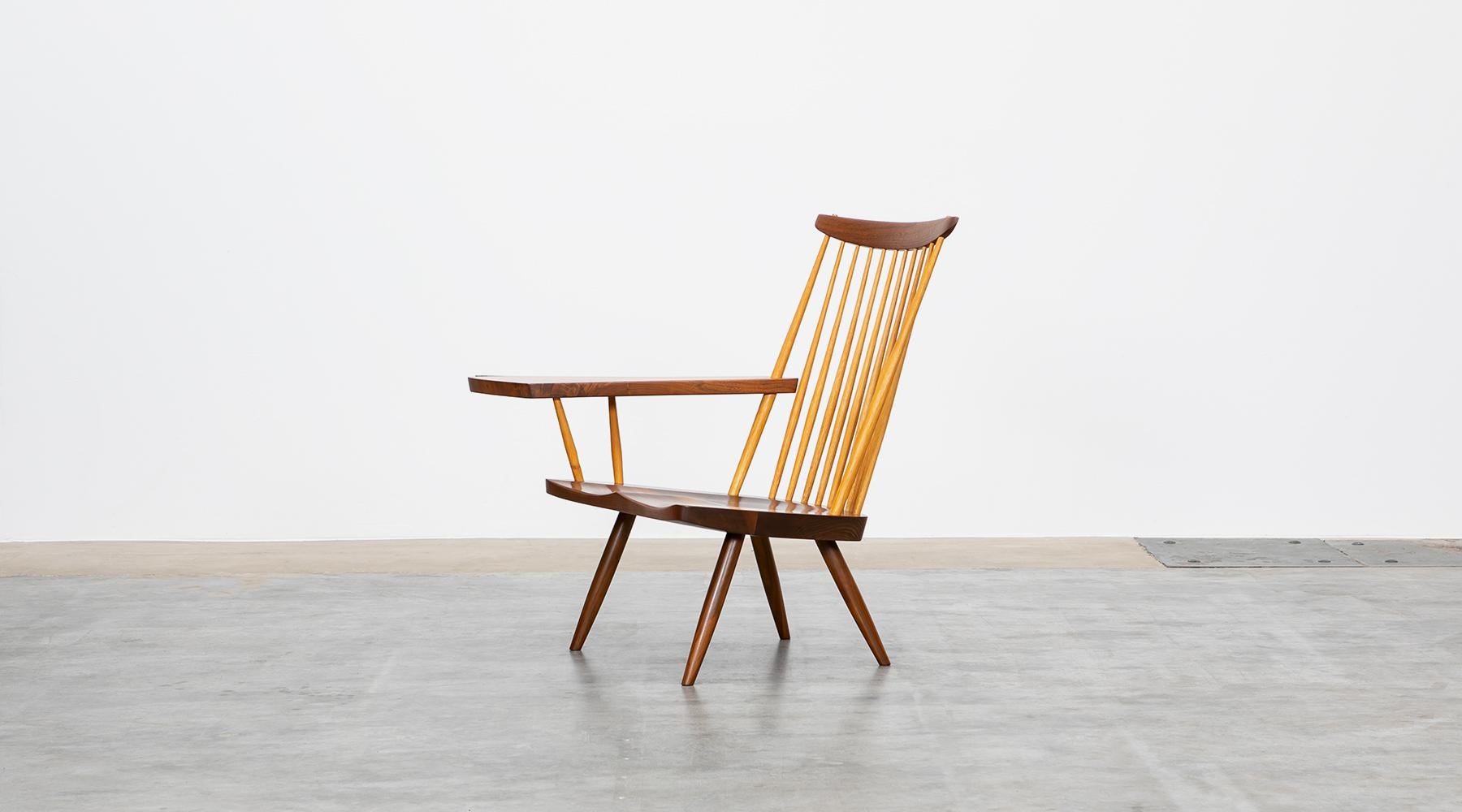 Armchair in walnut designed by George Nakashima, USA, 1999.

This handcrafted armchair by George Nakashima has a beautifully figured American walnut armrest with an organic and subtle freeform edge. Manufactured by Nakashima Studios in
