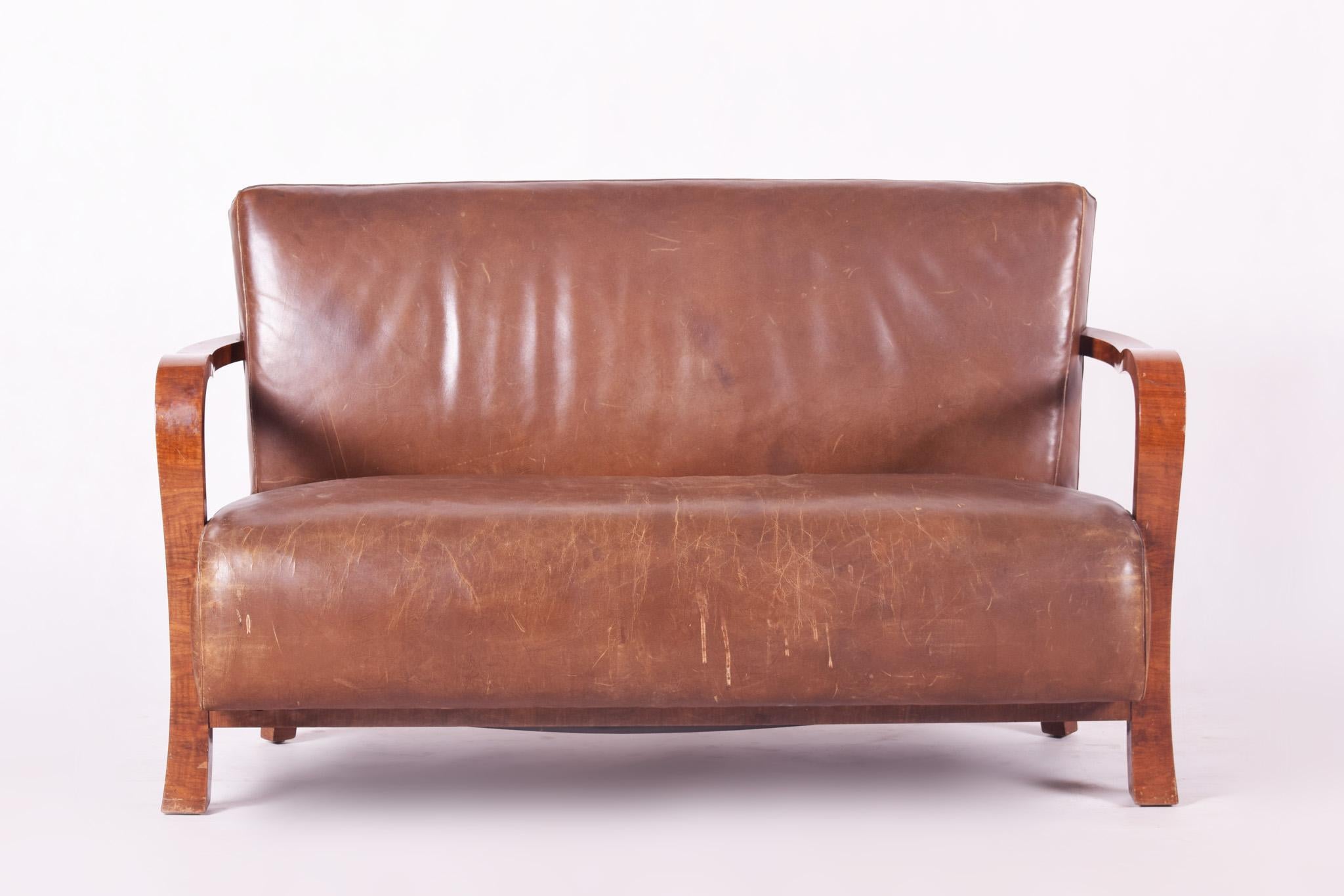 Czech Art Deco three-piece suit.
Material: Walnut, leather
Original well preserved condition

Armchair dimensions:
Height 85 cm (33.46 in)
Width 67 cm (26.38 in)
Depth 73 cm (28.74 in)
Seat height 42 cm (16.54 in)

Sofa dimensions:
Height