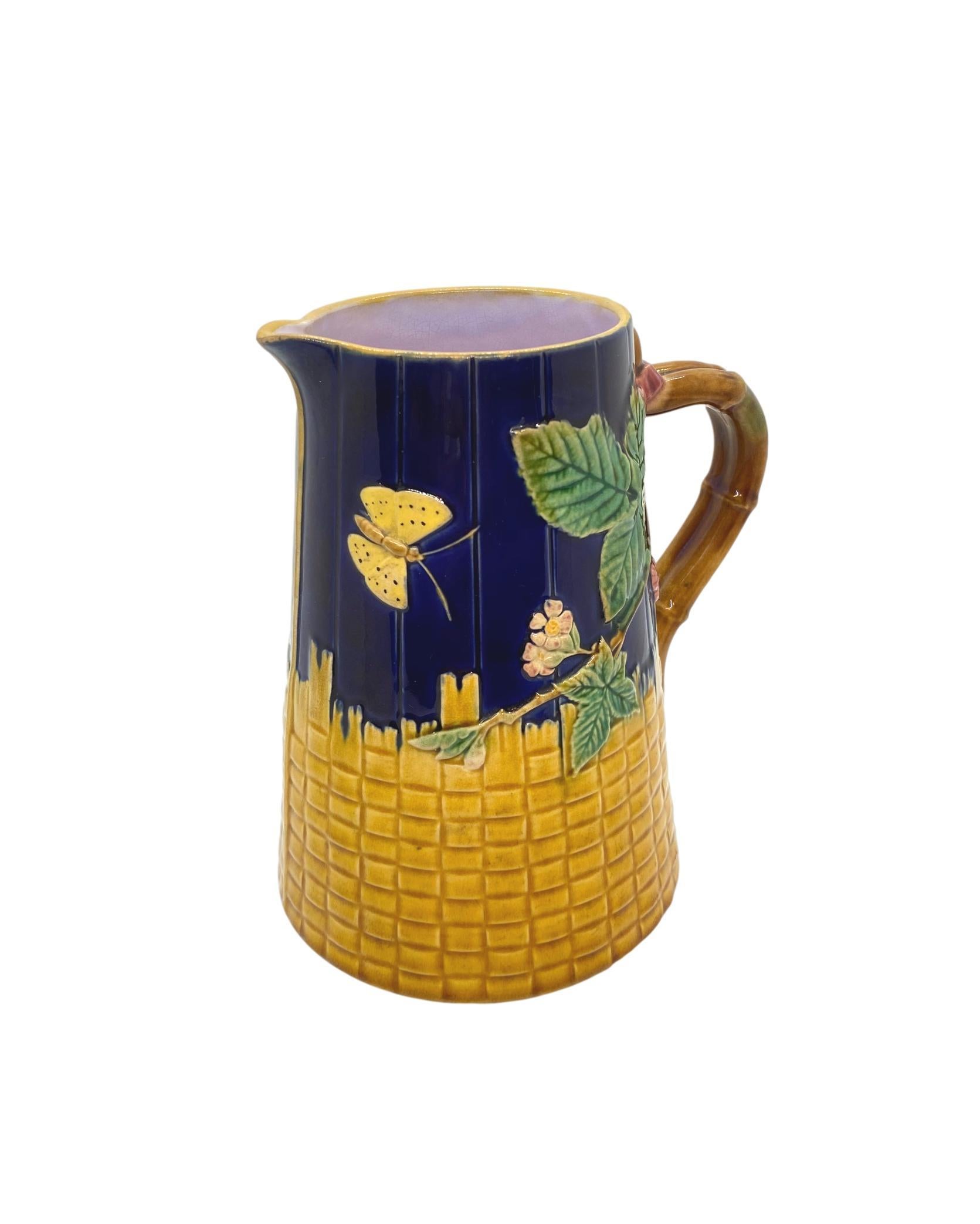 T. C. Brown-Westhead Moore & Co. Majolica Butterfly Pitcher, on cobalt blue-glazed simulated wooden staves and Yellow Basketweave, with faux bamboo handles, the interior glazed in lavender, the reverse with British Registry Mark for 19 September