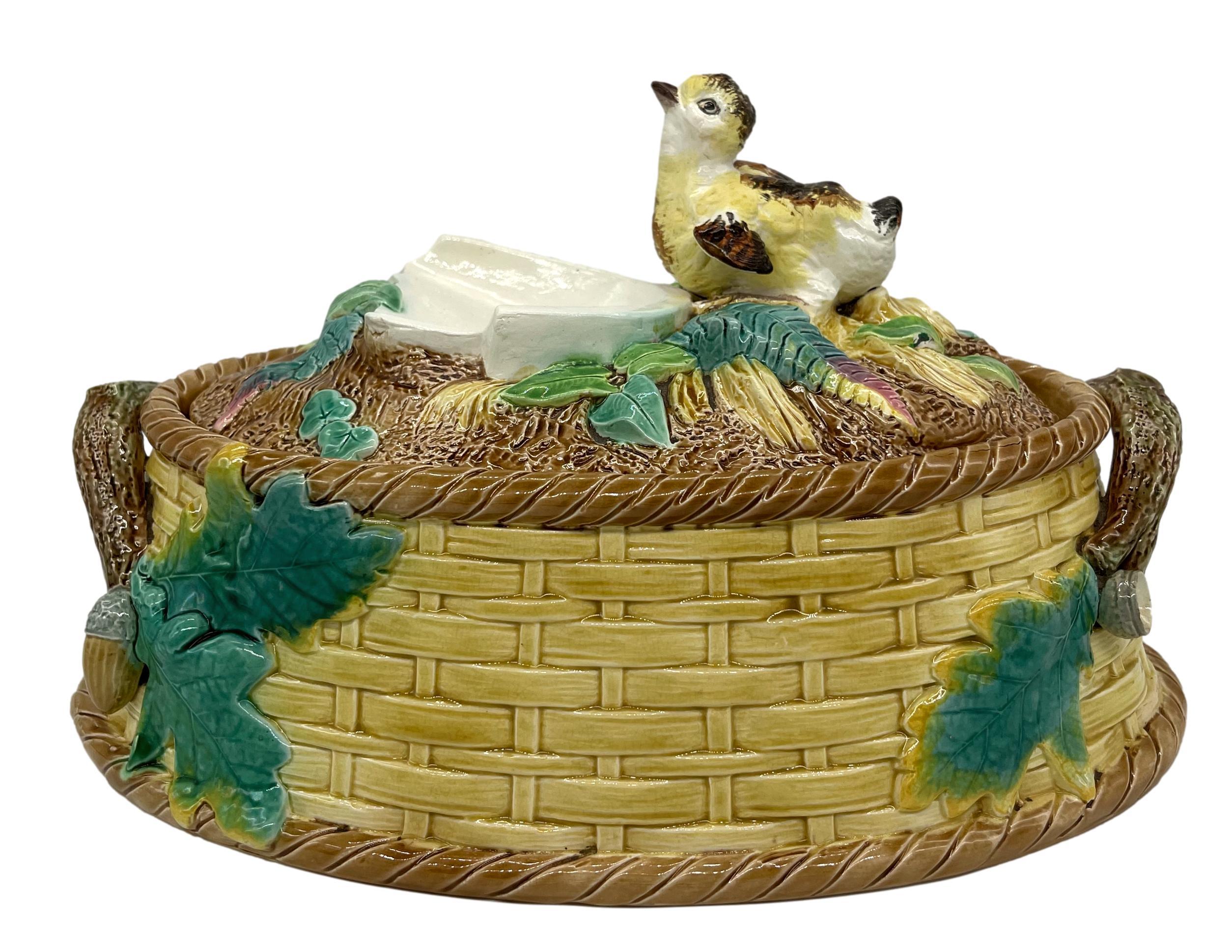 T.C. Brown-Westhead, Moore & Co. Majolica Game Pie Tureen, the base molded as a yellow-glazed woven basket with applied branch handles terminating with oak leaves and acorns, the mound-form cover with ferns and leaves, surmounted by a single grouse