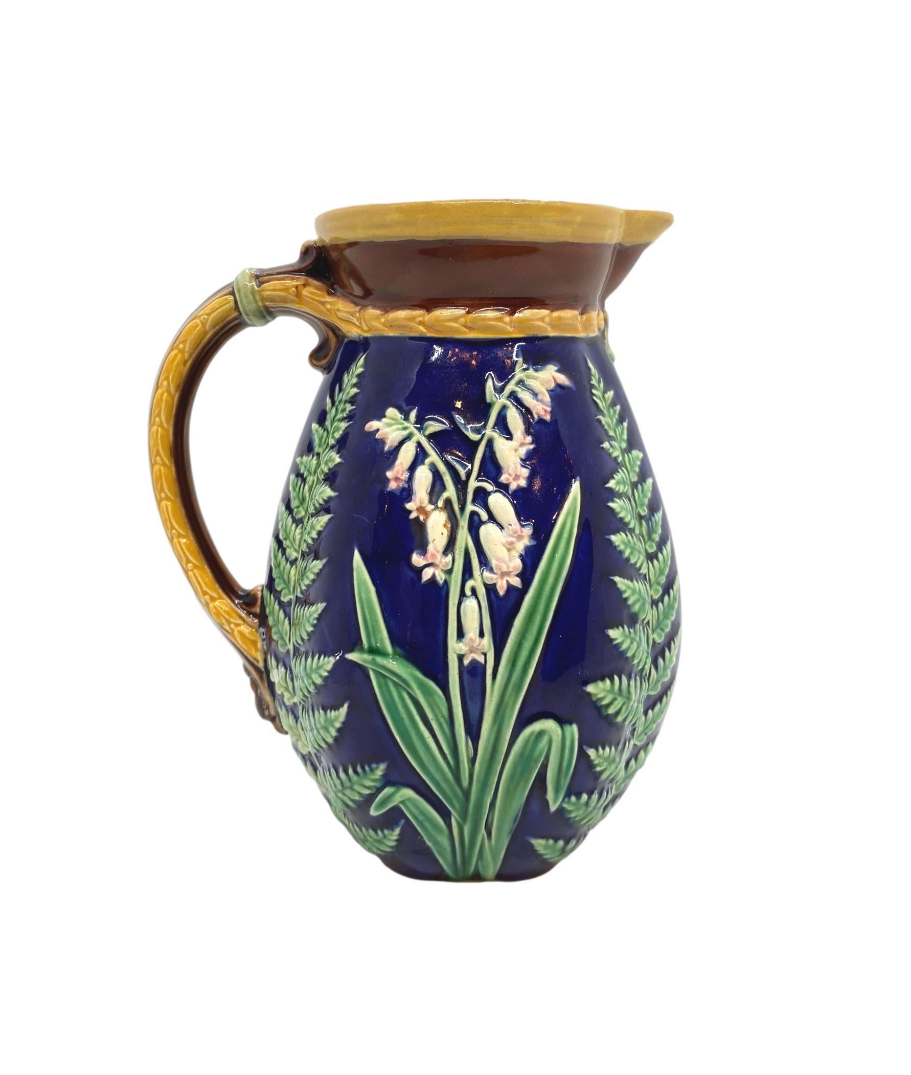 T.C. Brown-Westhead Moore & Co. Majolica Pitcher, Lilies of the Valley and Ferns on a Cobalt Blue ground, the reverse with British Registry lozenge for 24 September 1871, with painted design number and impressed mark for T.C. Brown-Westhead Moore &