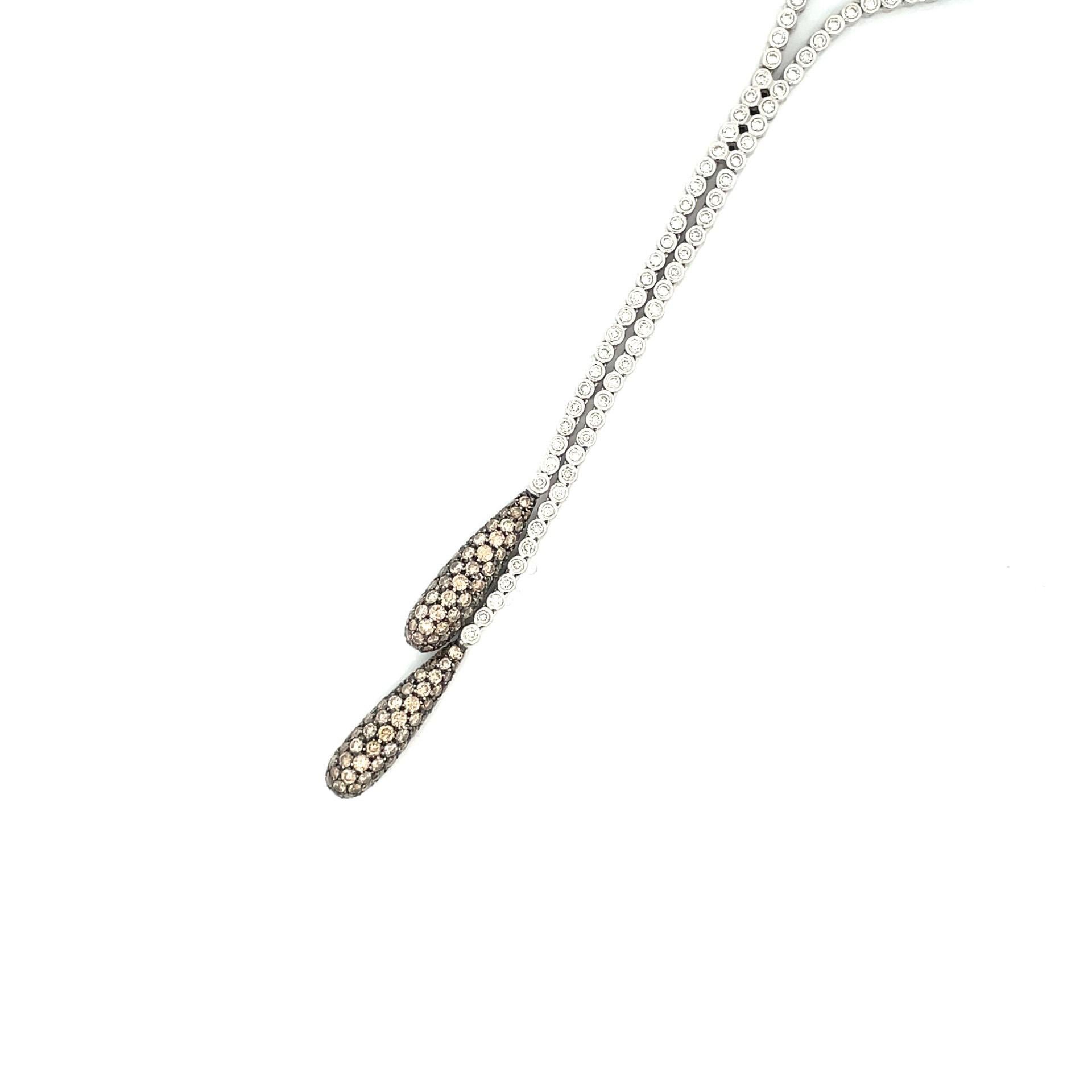 Enjoy this double pave drop pear shape necklace 18 kt white gold with natural white diamonds &  black rhodium finish around natural brown diamonds.

112 brilliant cut natural white diamonds 1.75ct total weight

143 brilliant cut natural brown