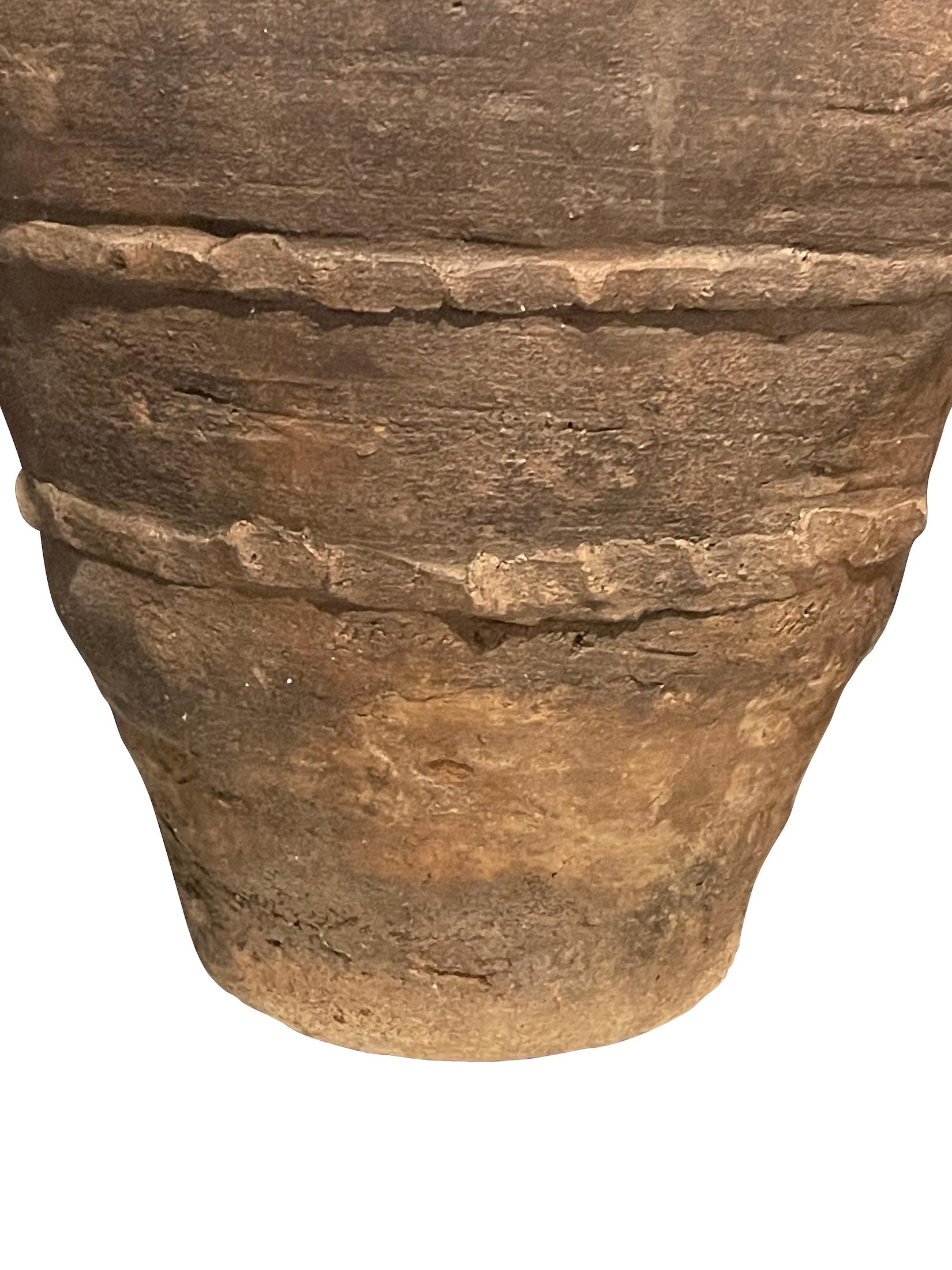 19th Century Spanish terracotta olive pot.
Unearthed from a very large family run olive oil producing business in southern Spain.
Brown in color with raised horizontal decorative details.
Beautiful and natural aged patina.
One of many pieces