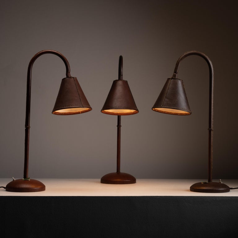 Brown wrapped leather table lamps by Valenti. Designed and manufactured in Spain, circa the 1970s. Purchased as dead stock. Fully wrapped leather table lamps with a shade that swivels. On and off toggle switch at the base. Holds one E27 socket type,