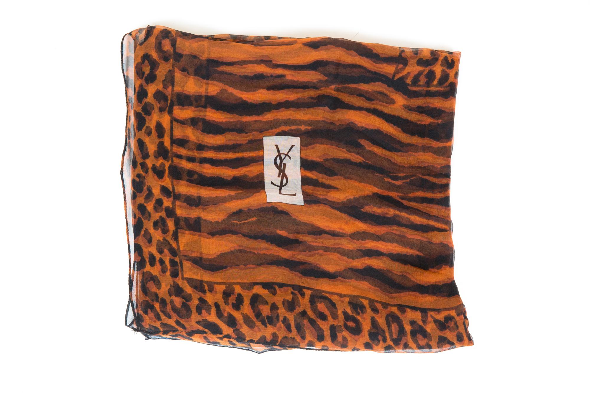 Gorgeous Saint Laurent YSL brown georgette silk shawl featuring a large size, a black animal print motive, a logo signature.
Marked YSL
53.1in. (135cm) X 53.1in. (135cm)  In good vintage condition.  
Made in France.  
We guarantee you will receive