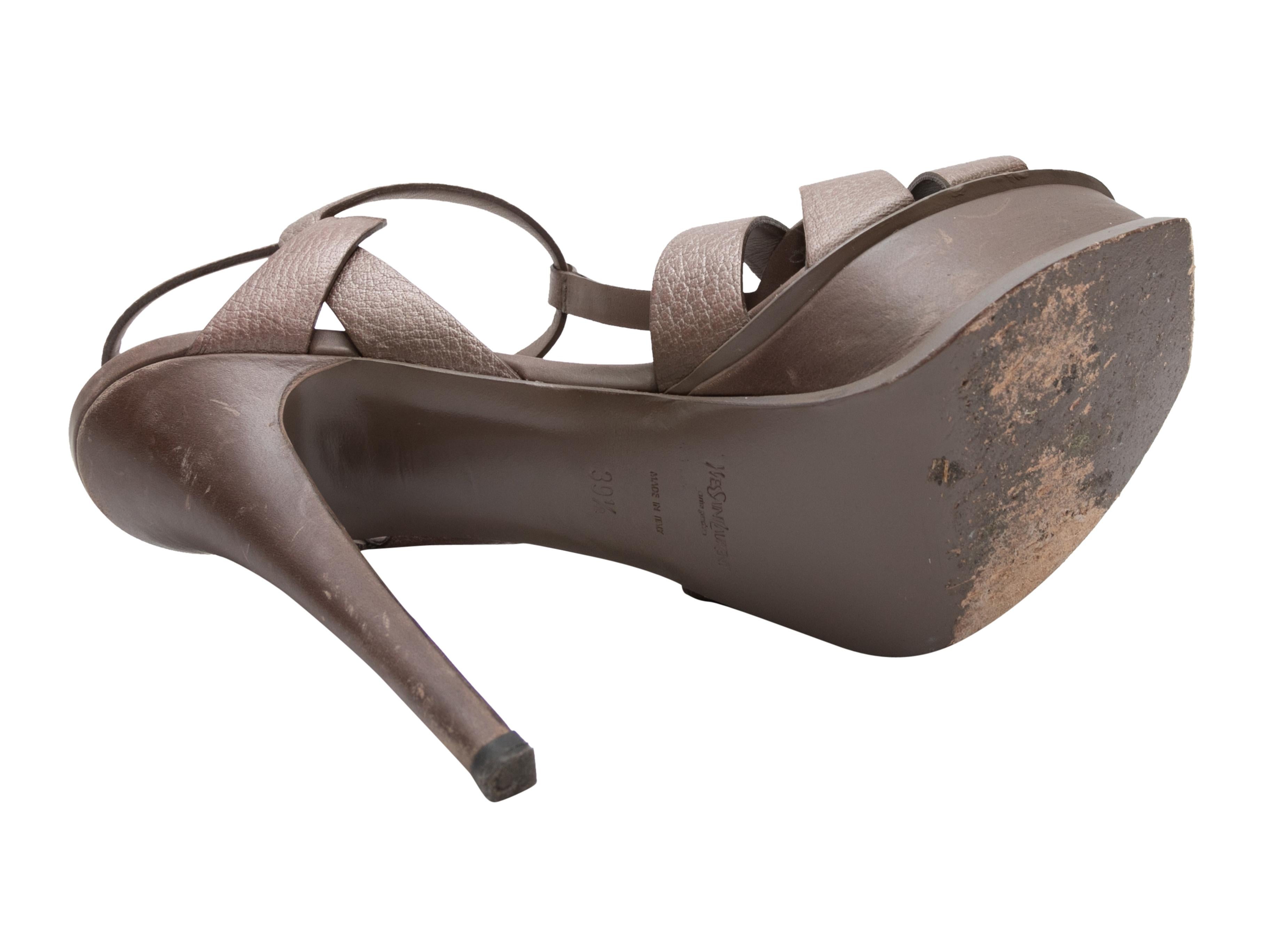 Brown leather Tribute platform heeled sandals by Yves Saint Laurent. Buckle closures at ankle straps. 1