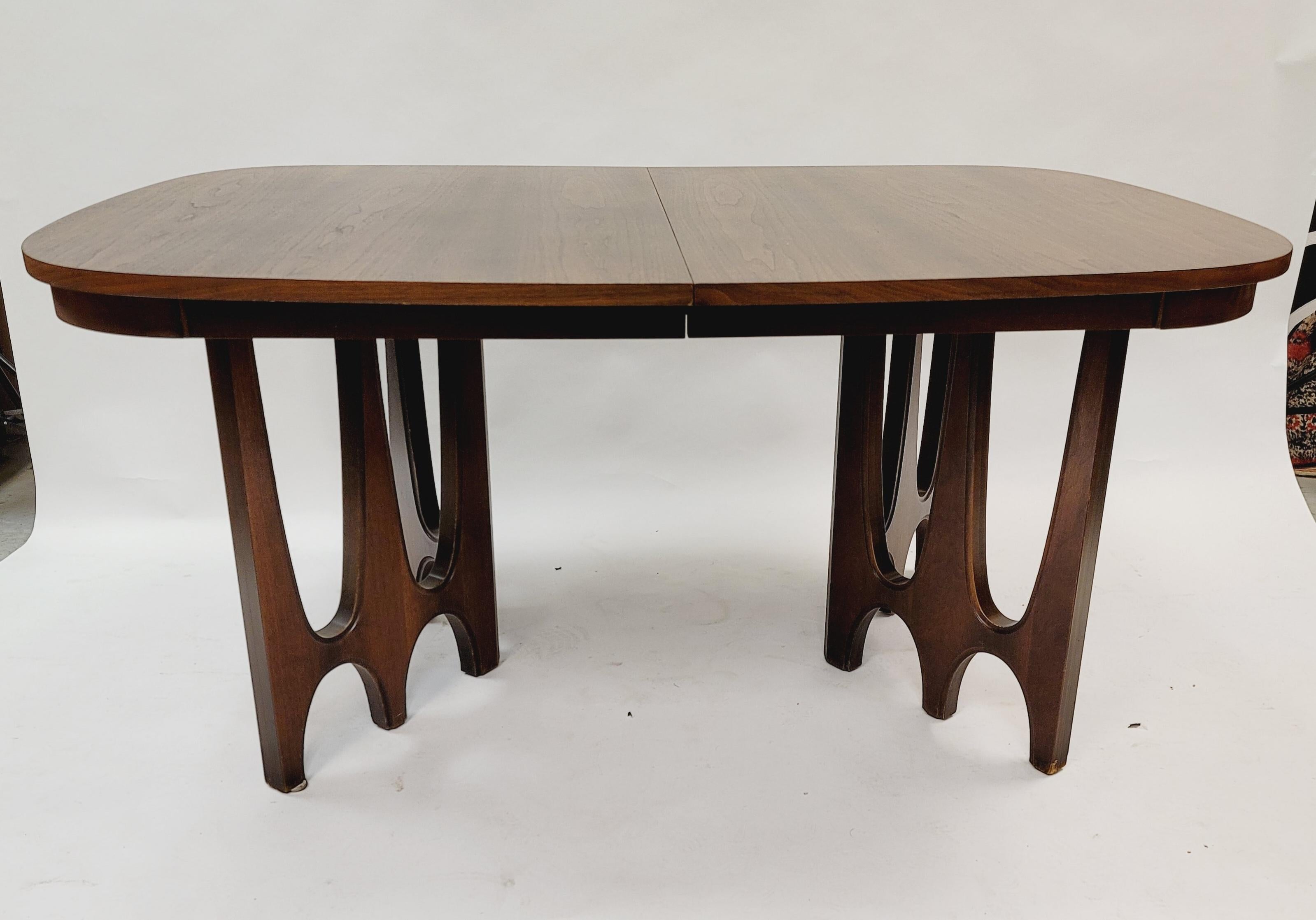 This Broyhill Brasilia dining table is crafted from walnut includes one leaf. The base is the hard-to-find arched base pattern that coordinates so well with the Brasilia chairs.
Dimensions: 43