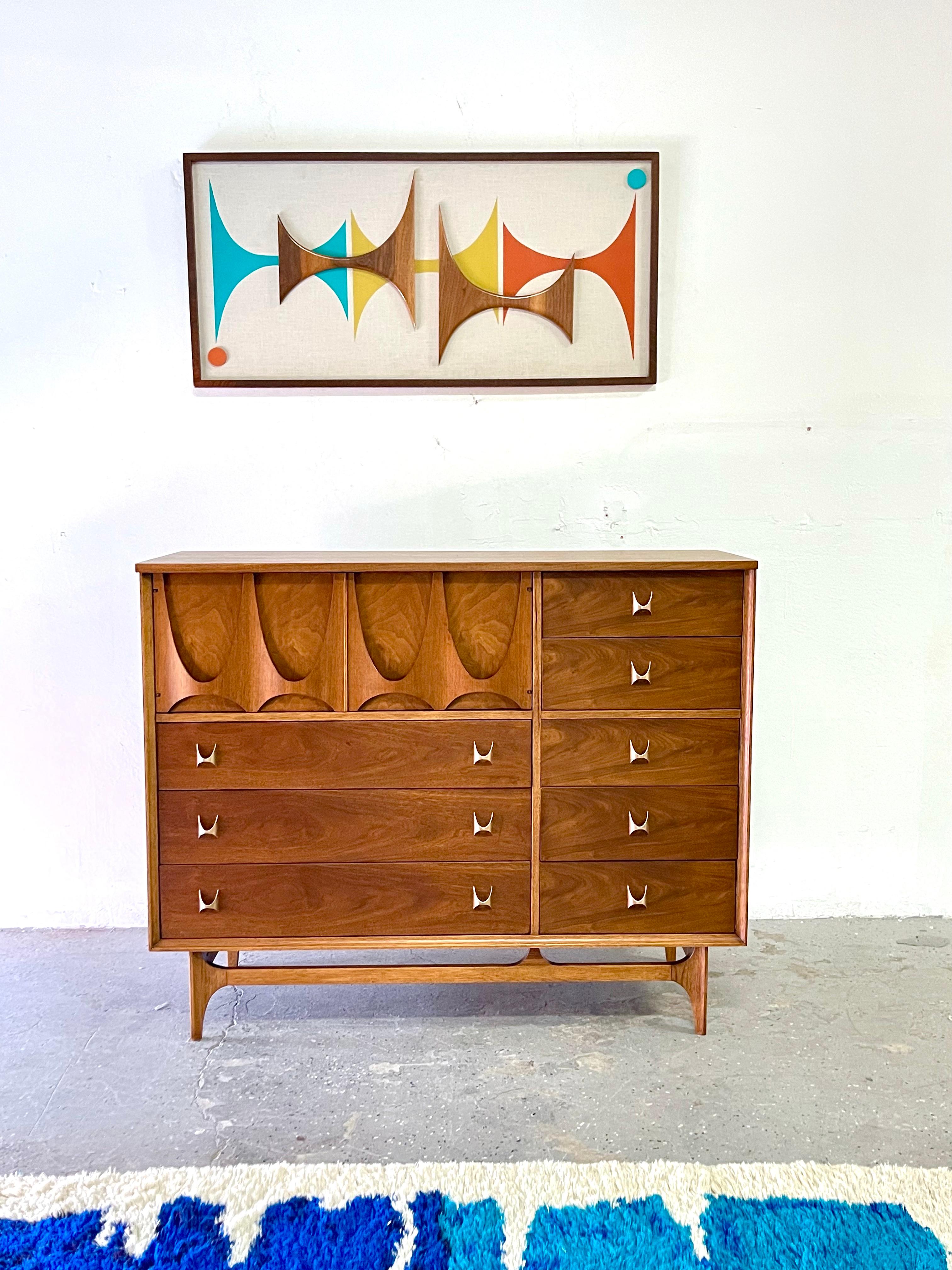 Broyhill Brasilia Magna mid century 8 drawer walnut highboy dresser gentlemans chest.

Very collectible Broyhill Premier Brasilia line “magna dresser”. Among the Brasilia bedroom pieces, this is the hardest to find. This is a fantastic storage