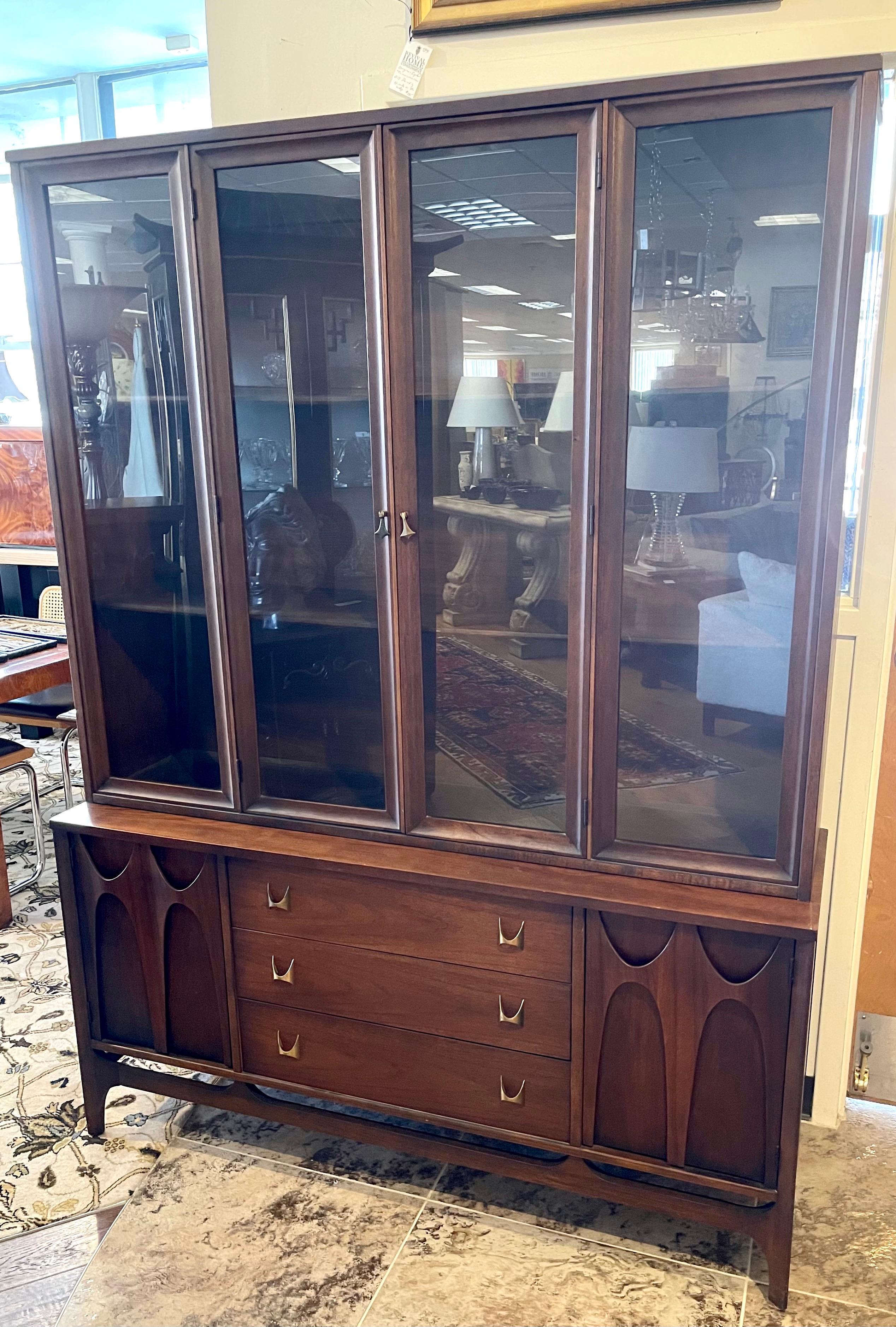 Rare and sought after Broyhill Brasilia two piece sculpted walnut breakfront. Part of a full dining room set we will me selling exclusively on 1stDibs this week. Great scale and lines to die for. All hallmarks present.
