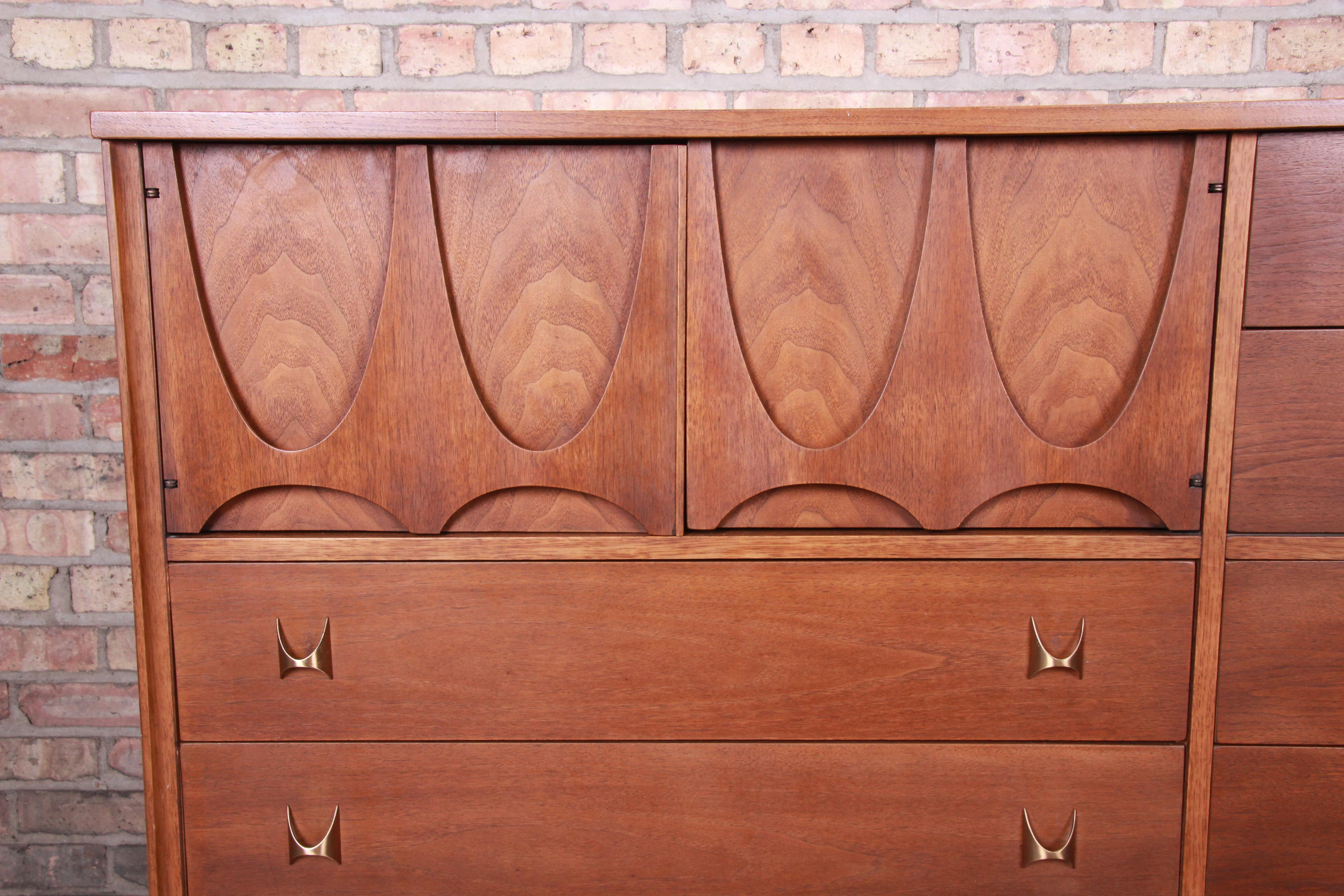 Brass Broyhill Brasilia Mid-Century Modern Sculpted Walnut Magna Dresser Chest, 1962