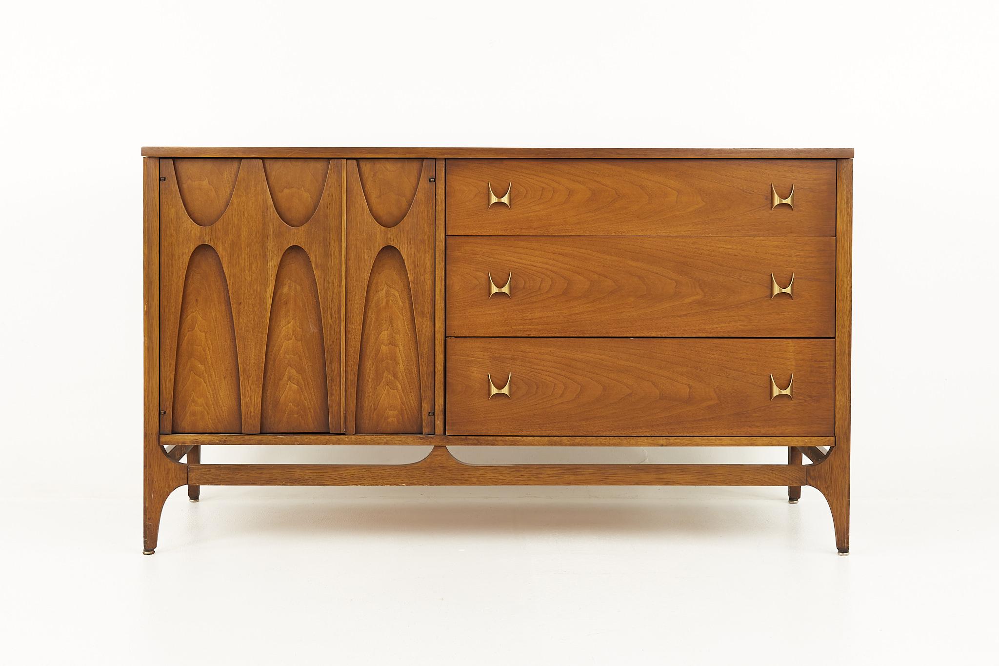 Broyhill Brasilia Mid Century offset door sideboard credenza

This credenza measures: 54.25 wide x 19.25 deep x 31 inches high

All pieces of furniture can be had in what we call restored vintage condition. That means the piece is restored upon