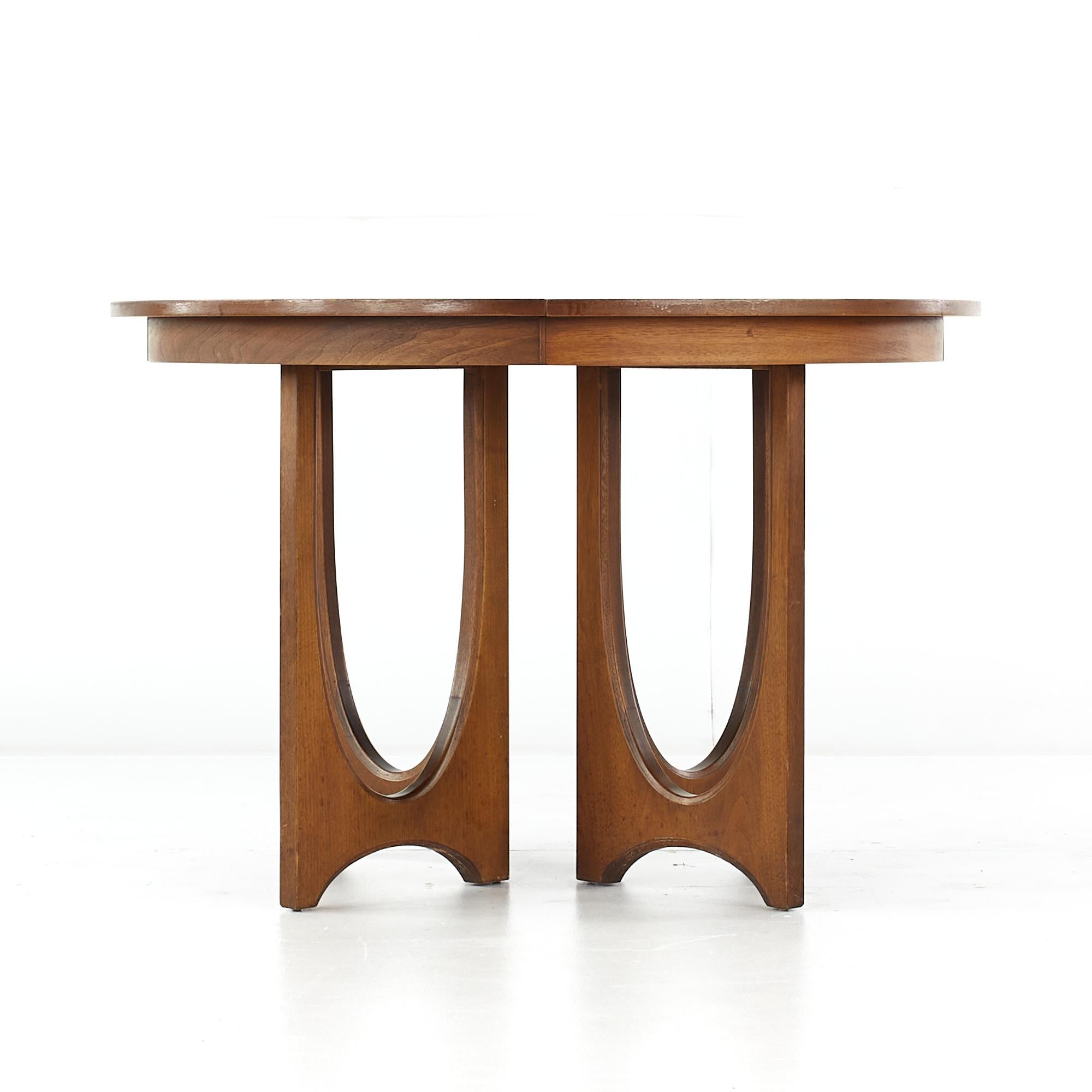 Broyhill Brasilia mid-century pedestal dining table with 1 leaf.

This table measures: 44 wide x 44.5 deep x 30 high, with a chair clearance of 26.75 inches, the leaf measures 12 inches wide, making a maximum table width of 56 inches when the leaf