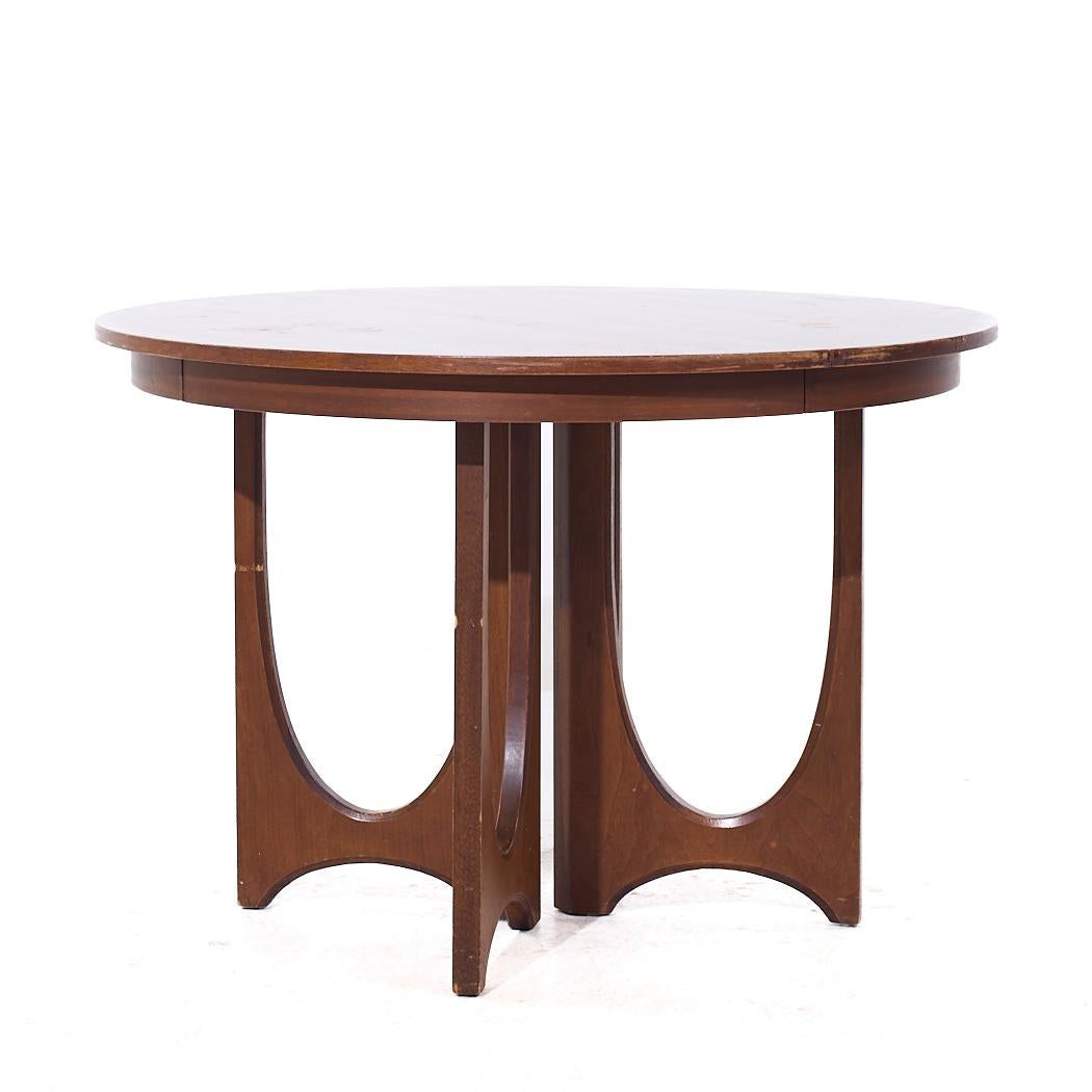 Broyhill Brasilia Mid Century Round Walnut Expanding Dining Table with 3 Leaves

This table measures: 44 wide x 44 deep x 30 inches high, with a chair clearance of 29 inches, each leaf measures 12 inches wide, making a maximum table width of 80
