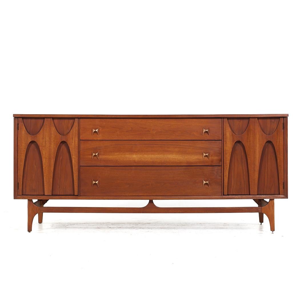Broyhill Brasilia Mid Century Walnut 72 inch 9 Drawer Lowboy Dresser

This lowboy measures: 72 wide x 19 deep x 31 inches high

All pieces of furniture can be had in what we call restored vintage condition. That means the piece is restored upon