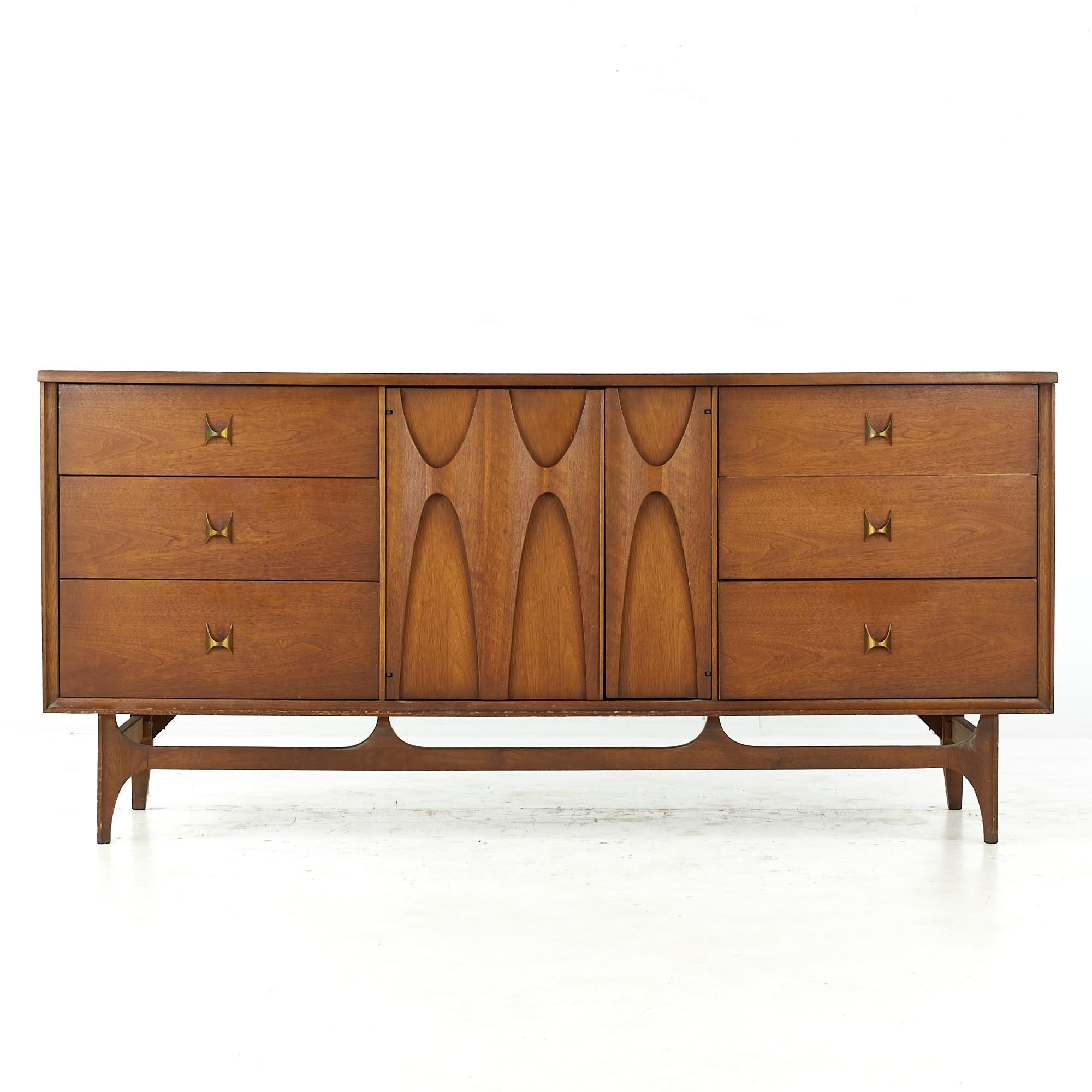 Broyhill Brasilia Mid Century walnut 9 drawer dresser

This dresser measures: 66 wide x 19 deep x 30.75 inches high

All pieces of furniture can be had in what we call restored vintage condition. That means the piece is restored upon purchase so