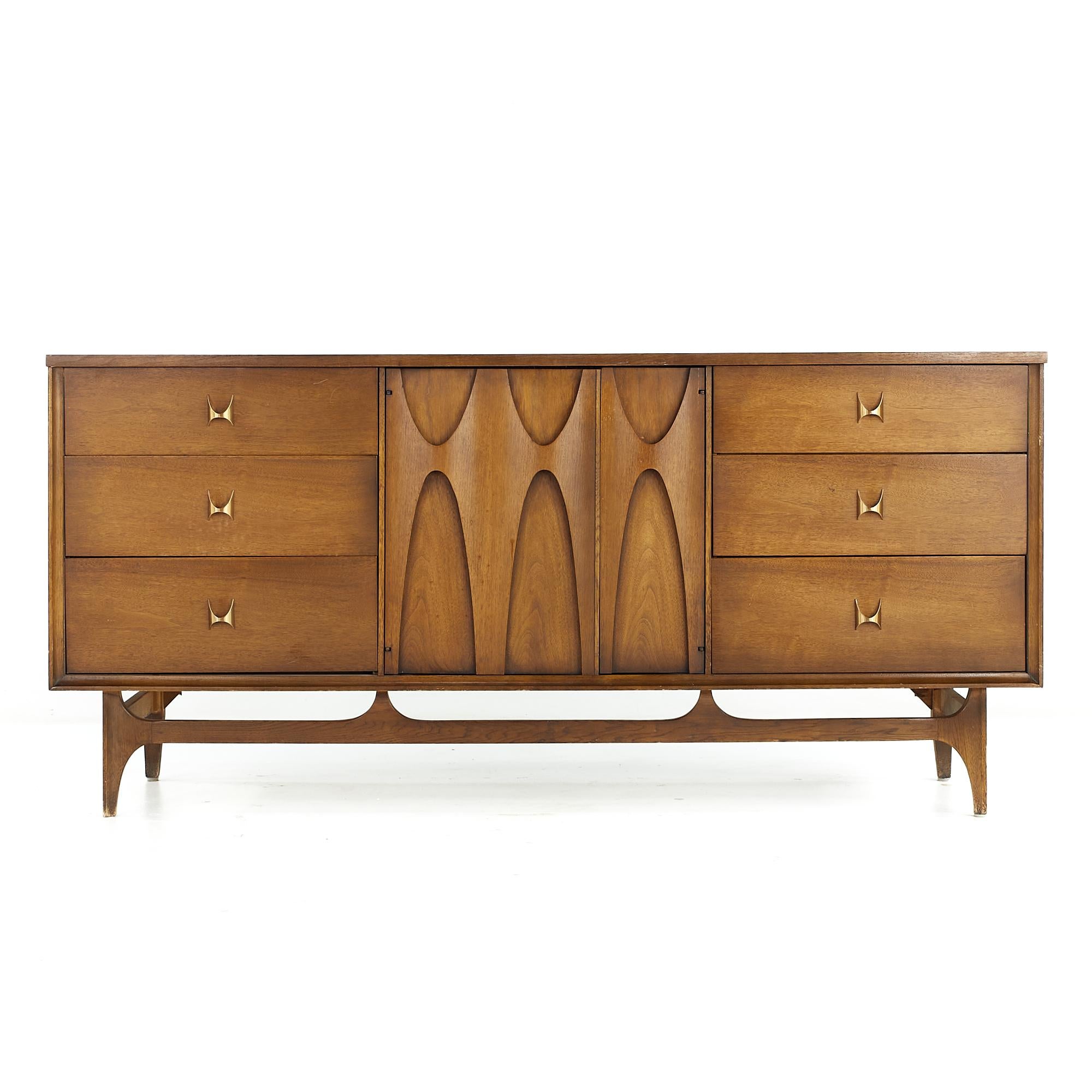 Broyhill Brasilia midcentury Walnut and Brass 9 Drawer Lowboy Dresser

This lowboy measures: 66 wide x 19 deep x 31 inches high

All pieces of furniture can be had in what we call restored vintage condition. That means the piece is restored upon