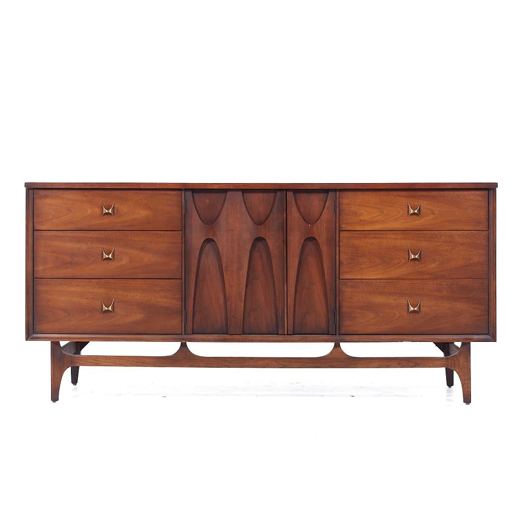 Broyhill Brasilia Mid Century Walnut and Brass 9 Drawer Lowboy Dresser

This lowboy measures: 66 wide x 19 deep x 31 inches high

All pieces of furniture can be had in what we call restored vintage condition. That means the piece is restored upon