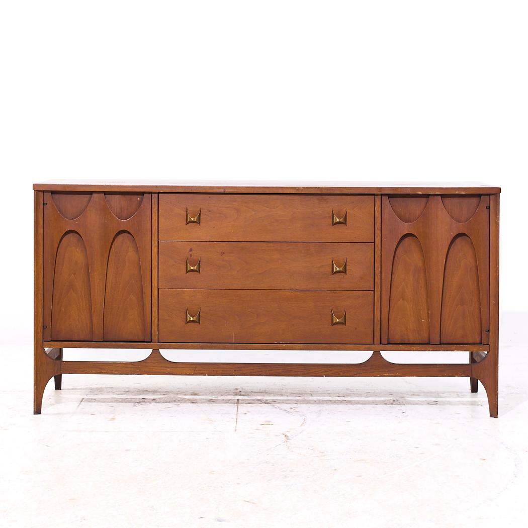 Broyhill Brasilia Mid Century Walnut and Brass Credenza

This credenza measures: 56 wide x 17 deep x 27.75 inches high

All pieces of furniture can be had in what we call restored vintage condition. That means the piece is restored upon purchase so