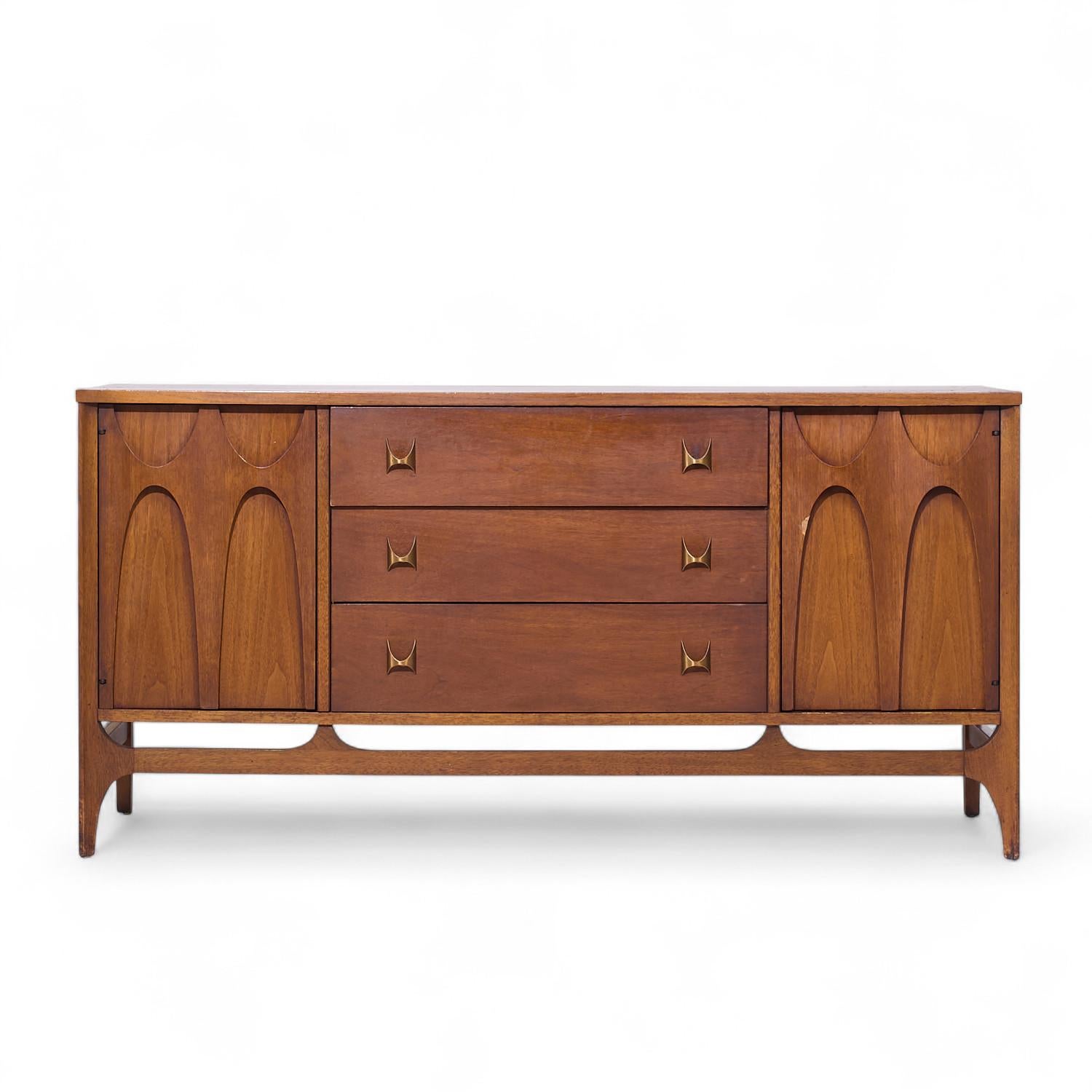 Broyhill Brasilia Mid Century Walnut and Brass Credenza

This credenza measures: 56 wide x 17 deep x 28 inches high

All pieces of furniture can be had in what we call restored vintage condition. That means the piece is restored upon purchase so