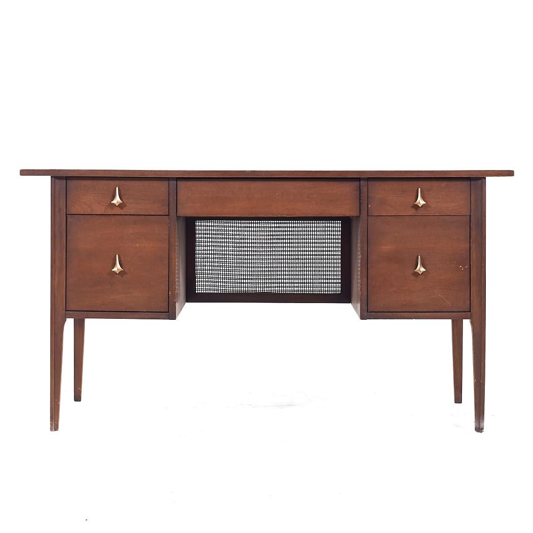 Broyhill Brasilia Mid Century Walnut and Brass Desk

This desk measures: 56 wide x 23 deep x 30 high, with a chair clearance of 24.5 inches

All pieces of furniture can be had in what we call restored vintage condition. That means the piece is