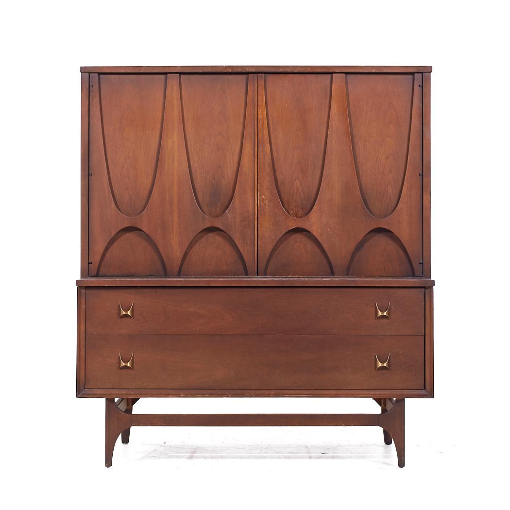 Broyhill Brasilia Mid Century Walnut and Brass Gentleman's Chest Armoire

This armoire measures: 44 wide x 19 deep x 49.75 inches high

All pieces of furniture can be had in what we call restored vintage condition. That means the piece is restored