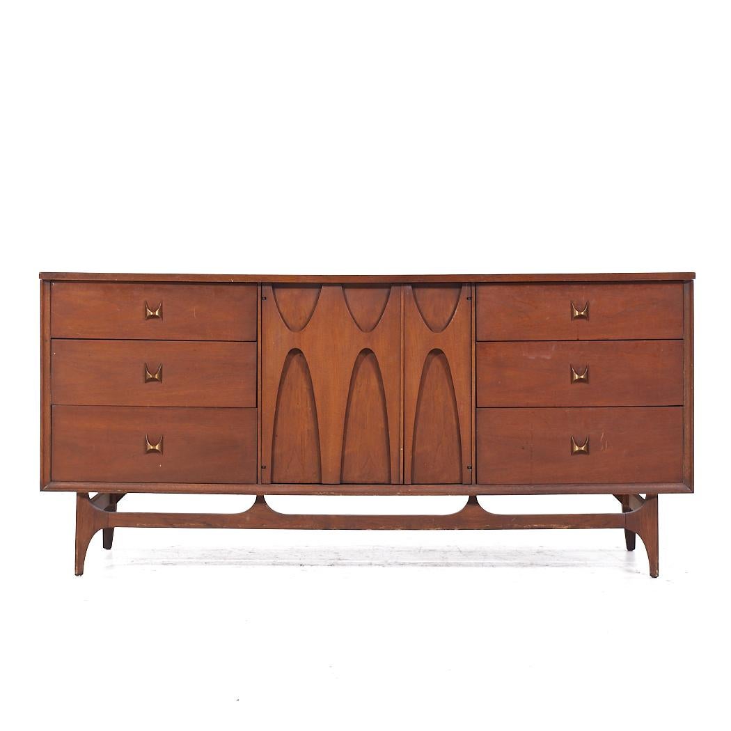 Broyhill Brasilia Mid Century Walnut and Brass Lowboy Dresser

This lowboy measures: 66 wide x 19 deep x 30 inches high

All pieces of furniture can be had in what we call restored vintage condition. That means the piece is restored upon purchase so