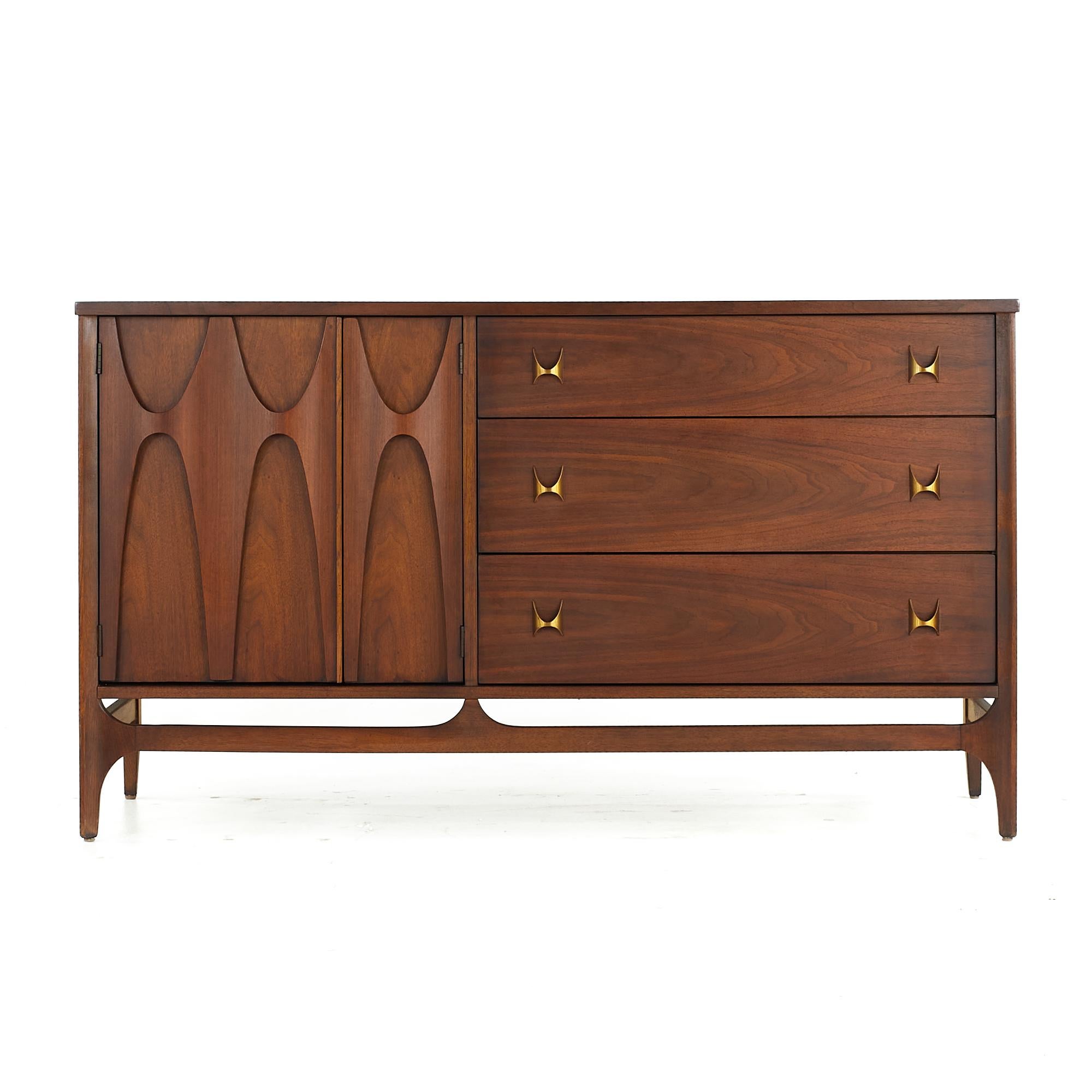 Broyhill Brasilia Mid Century Walnut and Brass Offset Buffet

This buffet measures: 54 wide x 19 deep x 31 inches high

All pieces of furniture can be had in what we call restored vintage condition. That means the piece is restored upon purchase so