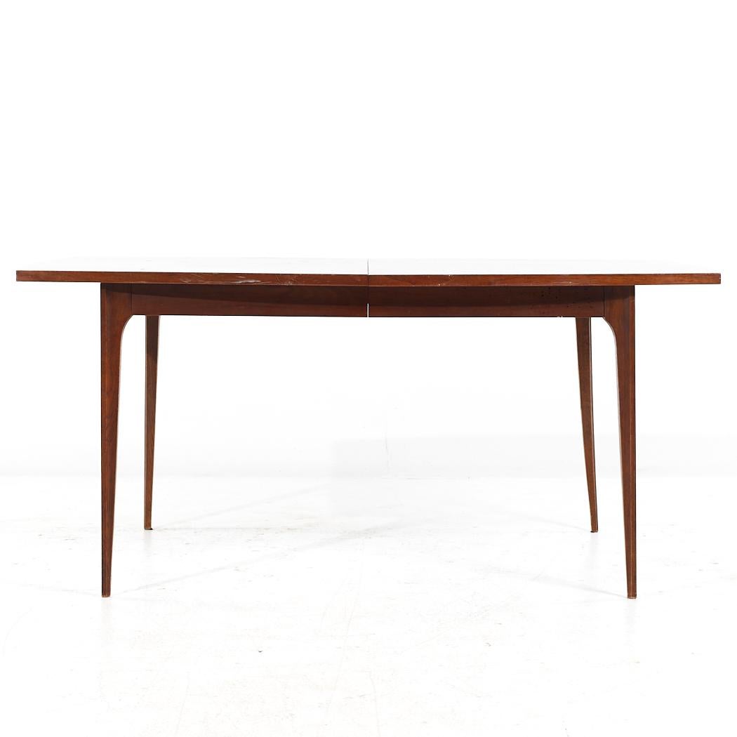 Broyhill Brasilia Mid Century Walnut Dining Table with 3 Leaves

This table measures: 66 wide x 40 deep x 29.75 inches high, with a chair clearance of 25.75 inches, each leaf measures 12 inches wide, making a maximum table width of 102 inches when