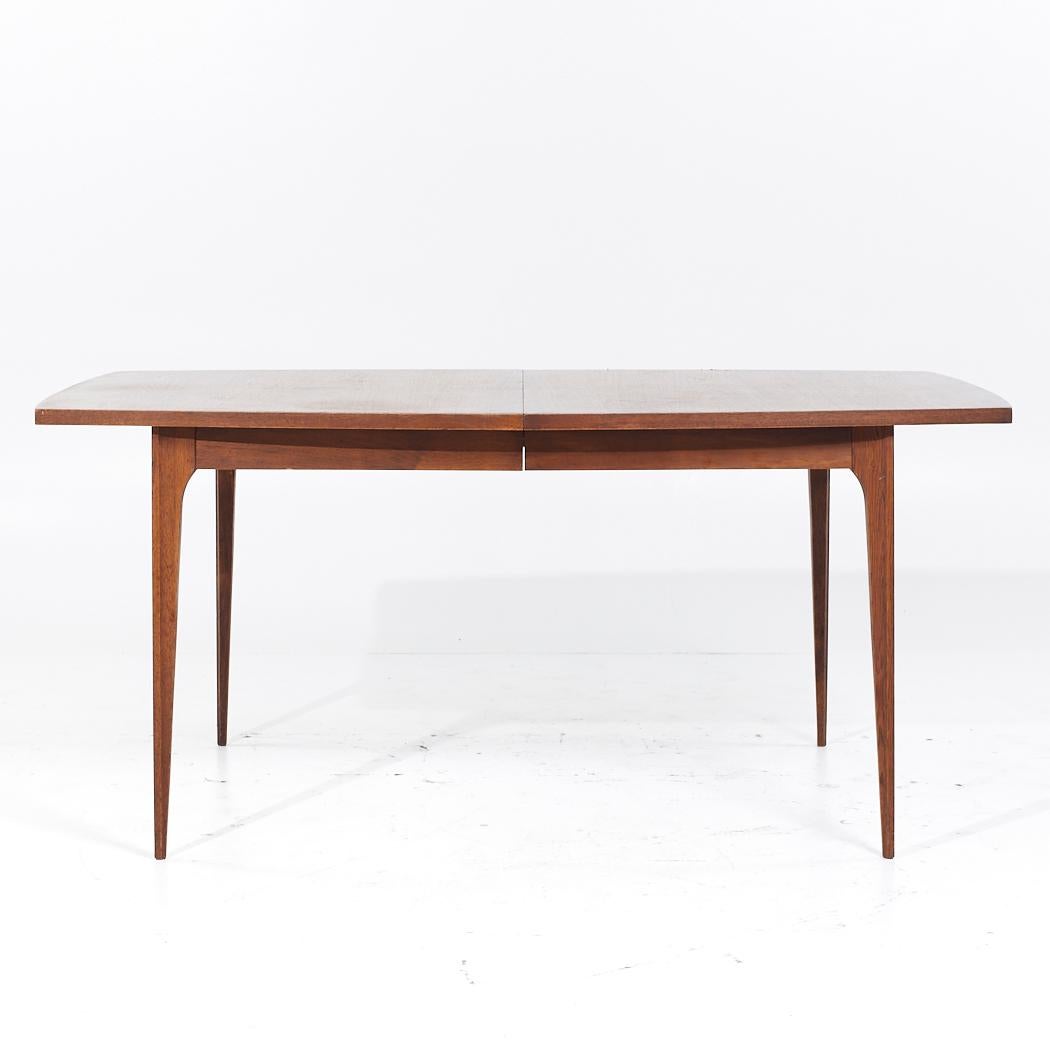 Broyhill Brasilia Mid Century Walnut Expanding Dining Table with 2 Leaves

This table measures: 66 wide x 40 deep x 29.75 inches high, with a chair clearance of 25.75 inches, each leaf measures 12 inches wide, making a maximum table width of 90